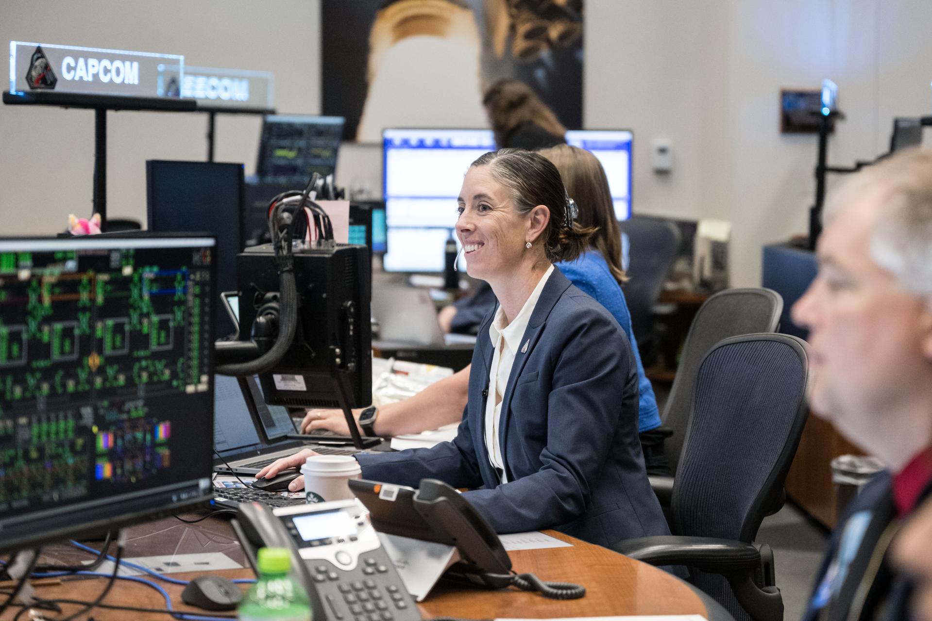 jsc2026e019614 (April 2, 2026) – NASA astronaut Chris Birch serves as capsule communicator (capcom) in the Mission Control Center at NASA’s Johnson Space Center during the mission’s translunar injection burn, which sent the crew in Orion out of Earth orbit and on a trajectory toward the Moon.