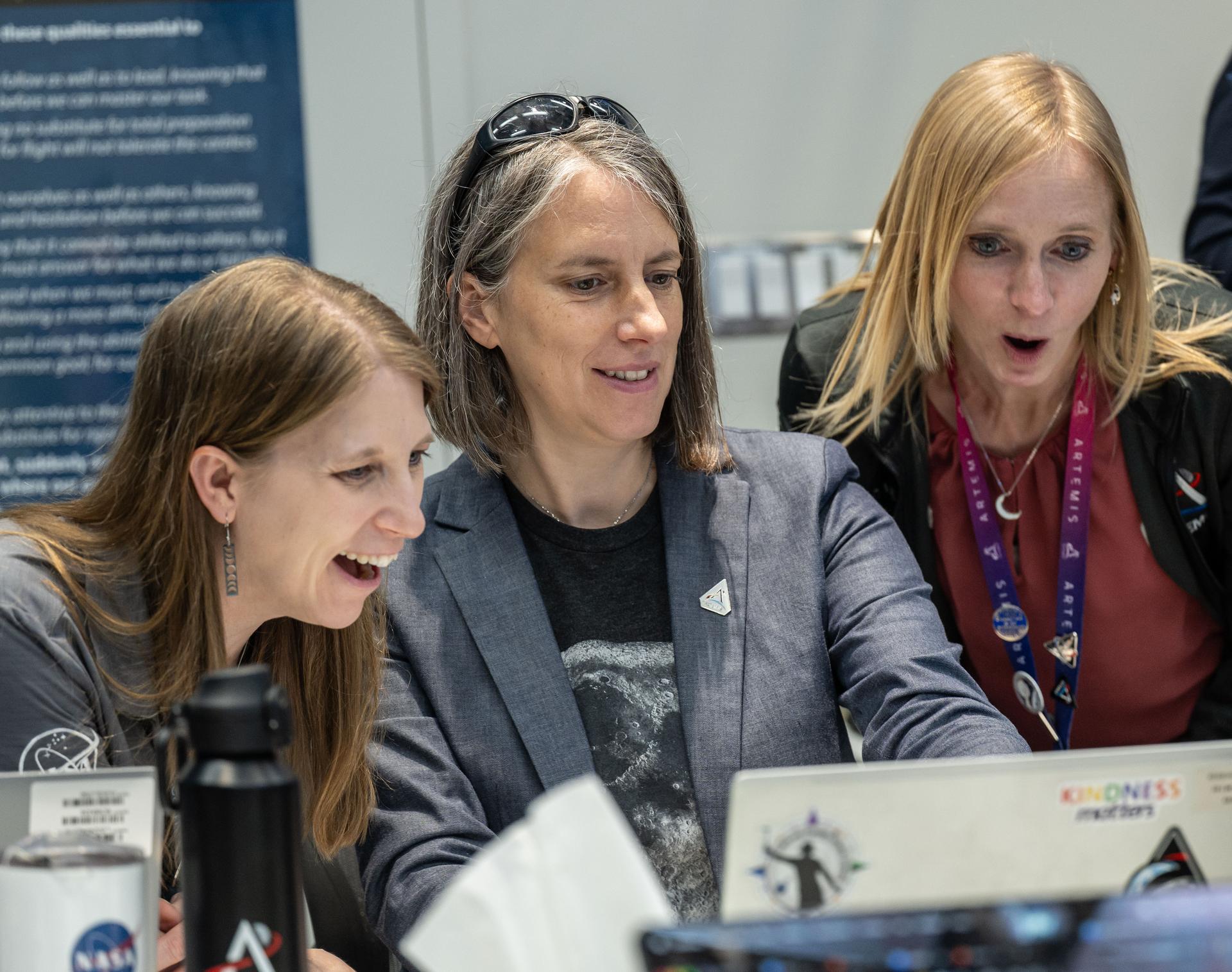 Artemis II lunar science team members, from left, Debra Needham, Juliane Gross, and Ryan Watkins, react to the astronauts' verbal observations of the Moon during their flyby on April 6, 2026. The science team trained the astronauts in geology and observation, both in the classroom and in the field. The team also built the lunar targeting plan that, like an International Space Station spacewalk plan, provides strong, detailed observation guidance, plus flexibility for the crew to make decisions based on what they’re seeing and experiencing in real time. The science team had many moments of celebration during the lunar flyby as the astronauts took images of the Moon and provided verbal descriptions of what they were seeing. This type of information reveals the geologic history of an area and will be critical to collect when future Artemis astronauts explore the Moon's surface. Credits: NASA/Luna Posadas Nava