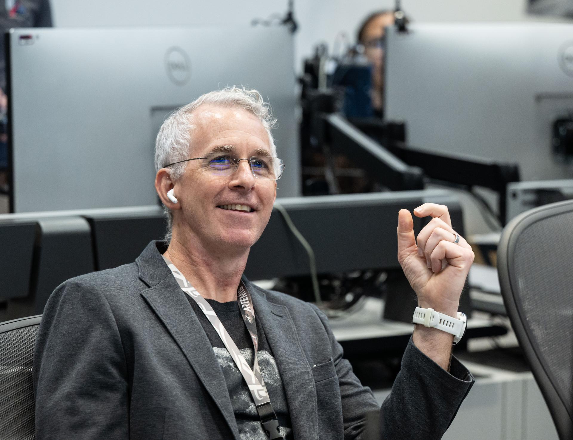 Artemis II lunar science team member, Ryan Ewing, reacts to the astronauts' verbal observations of the Moon during their flyby on April 6, 2026. Along with other lunar science team members, Ewing helped train the crew in geology both in the classroom and in the field. The science team also built the lunar targeting plan that, like an International Space Station spacewalk plan, provides strong, detailed observation guidance, plus flexibility for the crew to make decisions based on what they’re seeing and experiencing in real time. The science team had many moments of celebration during the lunar flyby as the astronauts took images of the Moon and provided verbal descriptions of what they were seeing. This type of information reveals the geologic history of an area and will be critical to collect when future Artemis astronauts explore the Moon's surface.  Credits: NASA/Luna Posadas Nava