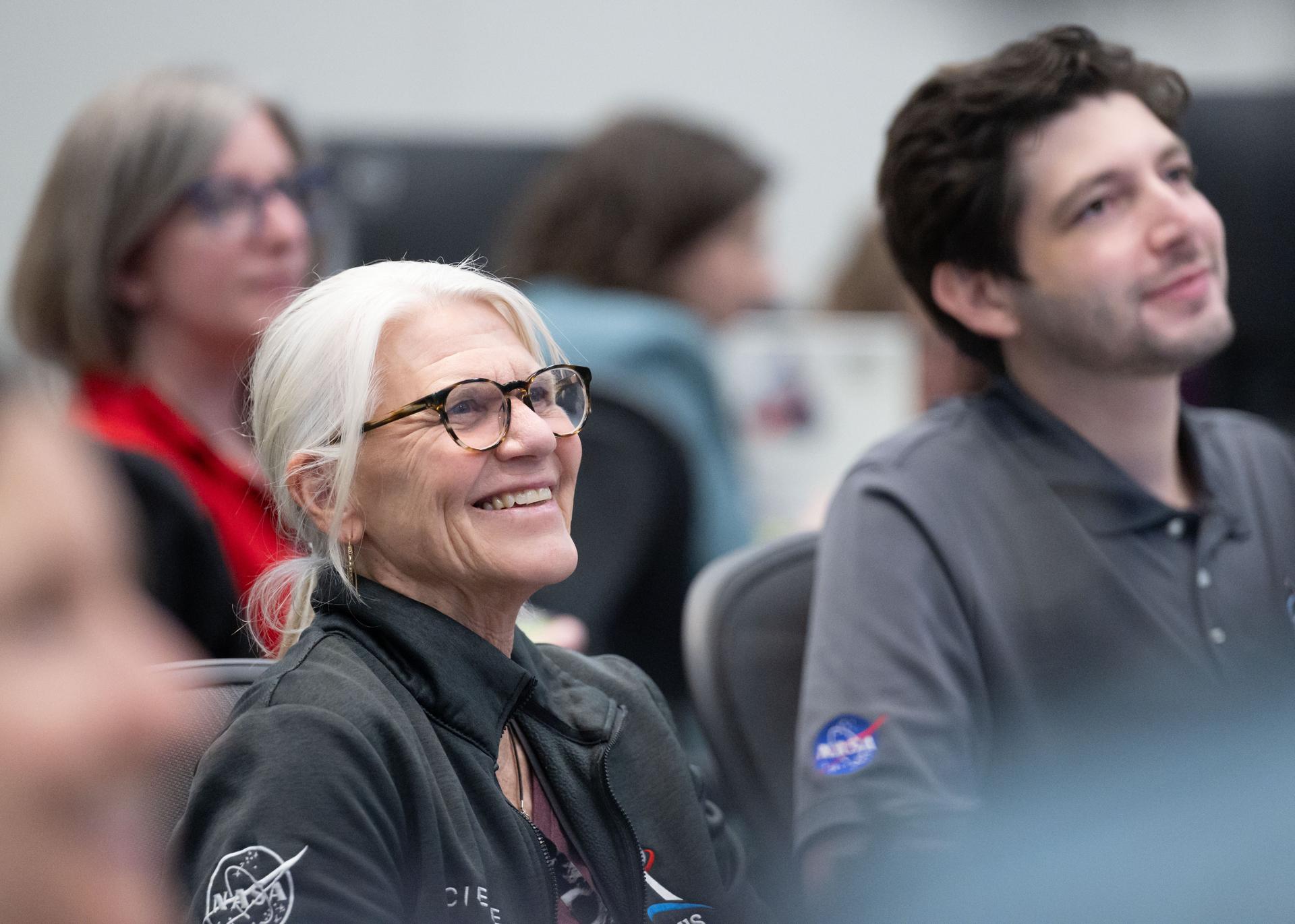 Artemis II lunar science team members, from left, Cindy Evans, and Wilfredo Garcia Lopez, react to crew observations during the lunar flyby on April 6, 2026.  The team worked in the Science Evaluation Room (SER) in Mission Control at NASA’s Johnson Space Center in Houston. Built specifically for Artemis missions with these science priorities in mind, the SER is equipped to support rapid data interpretation, collaborative analysis, real-time decision making, and seamless coordination between the science and operations teams. Credits: NASA/Luna Posadas Nava