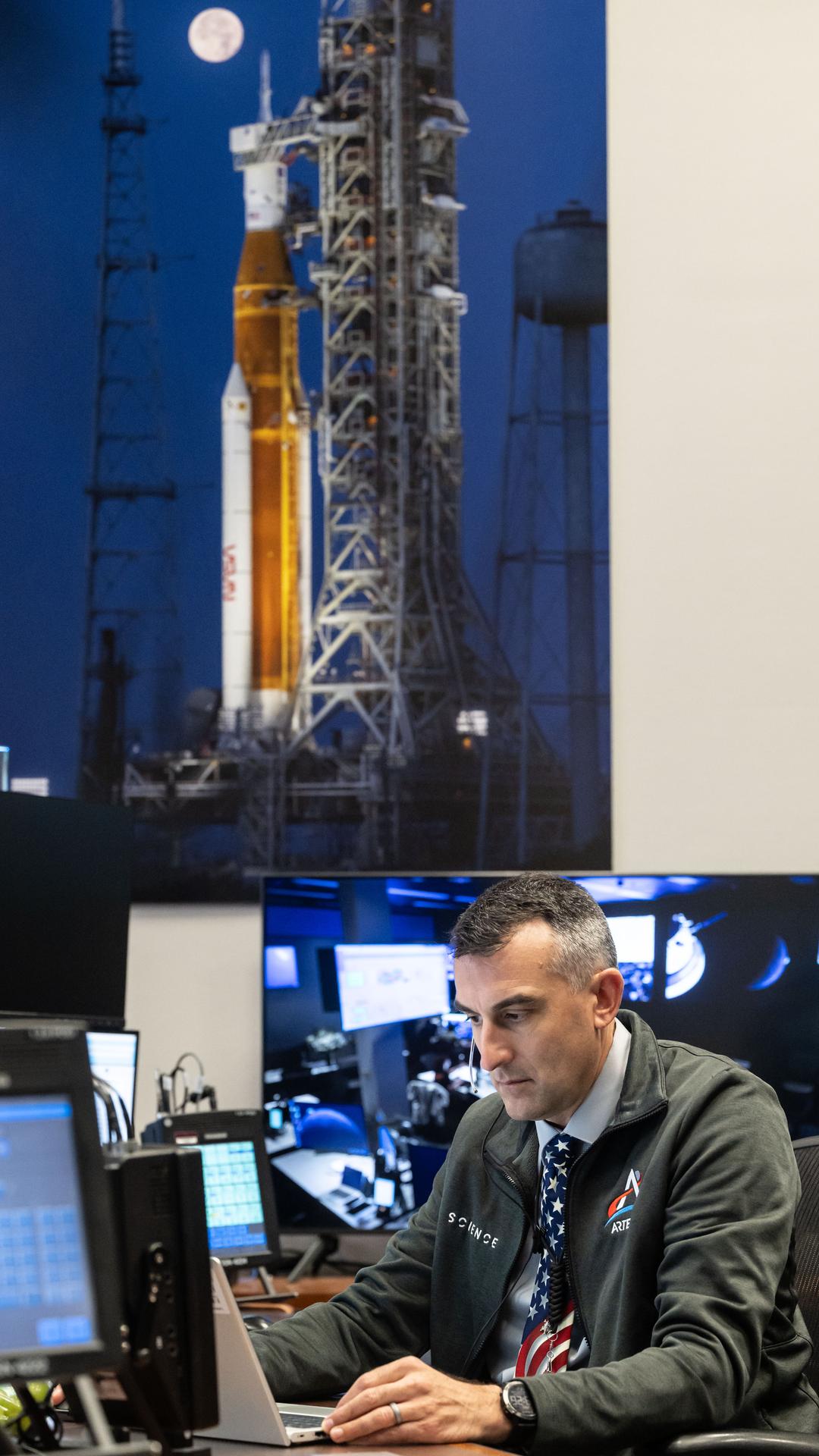 Artemis II science officer, Trevor Graff, is seen at the Science console in the White Flight Control Room in Mission Control at NASA's Johnson Space Center in Houston. Science officers are the senior flight controllers responsible for lunar science and geology objectives during Artemis missions. Credits: NASA/David DeHoyos