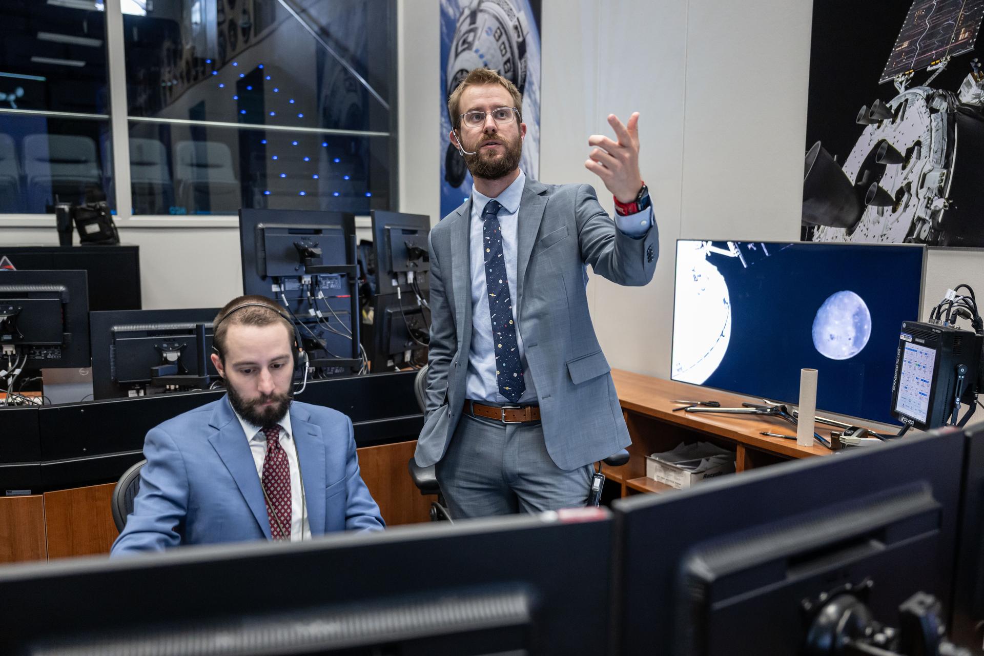 jsc2026e021749 (April 6, 2026) - Chris White, Lead INCO (Integrated Communications Officer) for Artemis II, and Matthew Johns, INCO Flight Controller, are pictured in the White Flight Control Room in the Mission Control Center at NASA’s Johnson Space Center during the Artemis II mission. This image was taken when NASA astronauts Reid Wiseman, Victor Glover, and Christina Koch, and CSA (Canadian Space Agency) astronaut Jeremy Hansen conducted the flyby of the Moon. Credit: NASA/Robert Markowitz