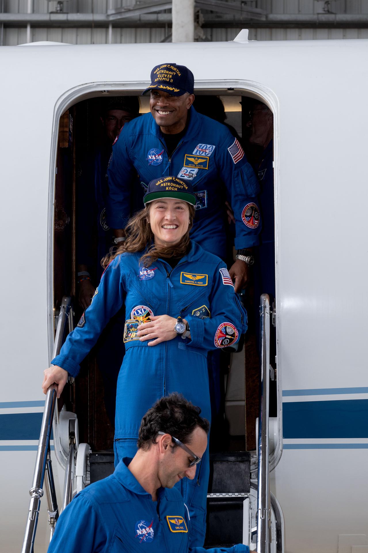 jsc2026e022269 (April 11, 2026) - Artemis II Pilot Victor Glover (top) and Mission Specialist Christina Koch (center) return home to...