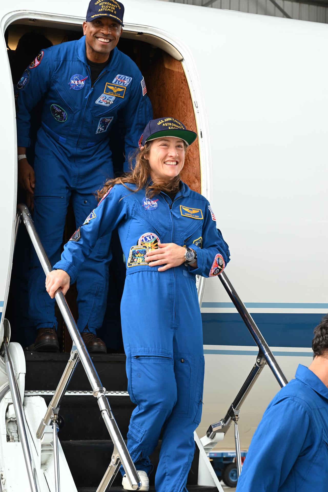 jsc2026e022274 (April 11, 2026) - Artemis II Pilot Victor Glover (top) and Mission Specialist Christina Koch (center) return home to...