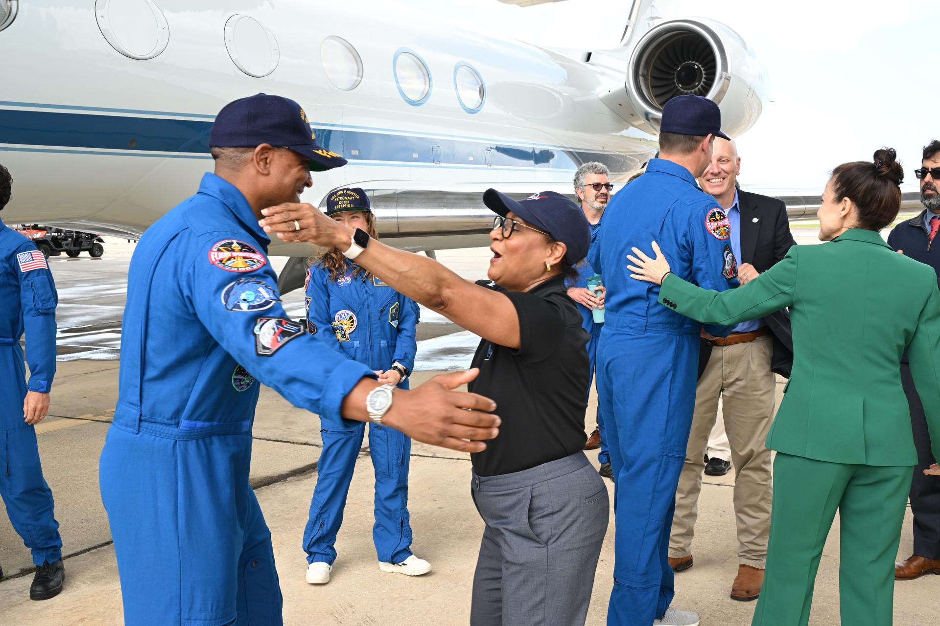jsc2026e022277 (April 11, 2026) - Artemis II Pilot Victor Glover is greeted by NASA's Johnson Space Center Director Vanessa Wyche on his return home to Houston, at Ellington Airport on Saturday, April 11, 2026, following a 10-day trip around the Moon and back. Glover and his three fellow crew members launched April 1, 2026, from NASA’s Kennedy Space Center in Florida, and splashed down off the coast of California on Friday, April 10, 2026.