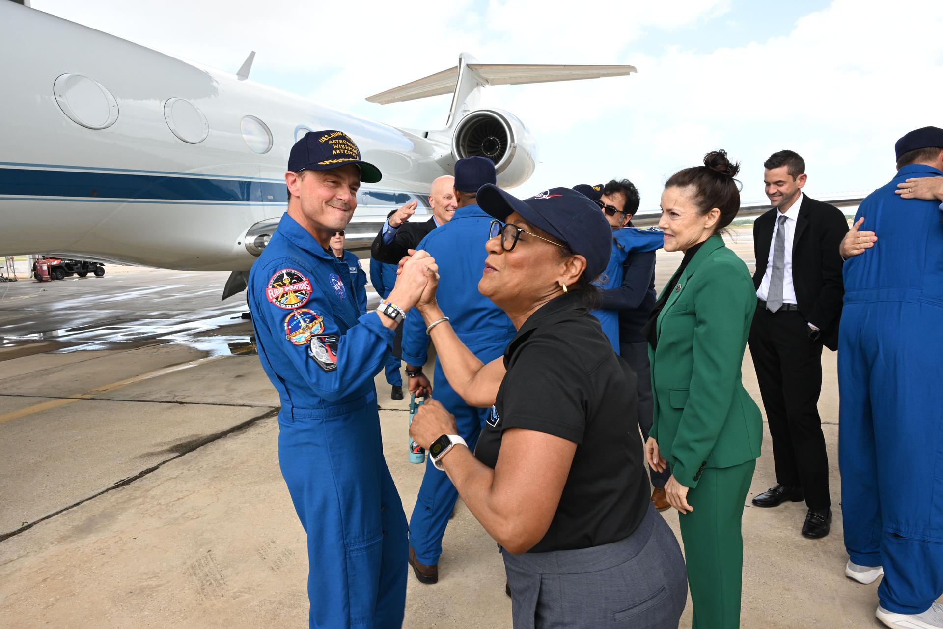 jsc2026e022279 (April 11, 2026) - Artemis II Commander Reid Wiseman is greeted by NASA's Johnson Space Center Director Vanessa Wyche on his return home to Houston, at Ellington Airport on Saturday, April 11, 2026, following a 10-day trip around the Moon and back. Wiseman and his three fellow crew members launched April 1, 2026, from NASA’s Kennedy Space Center in Florida, and splashed down off the coast of California on Friday, April 10, 2026.