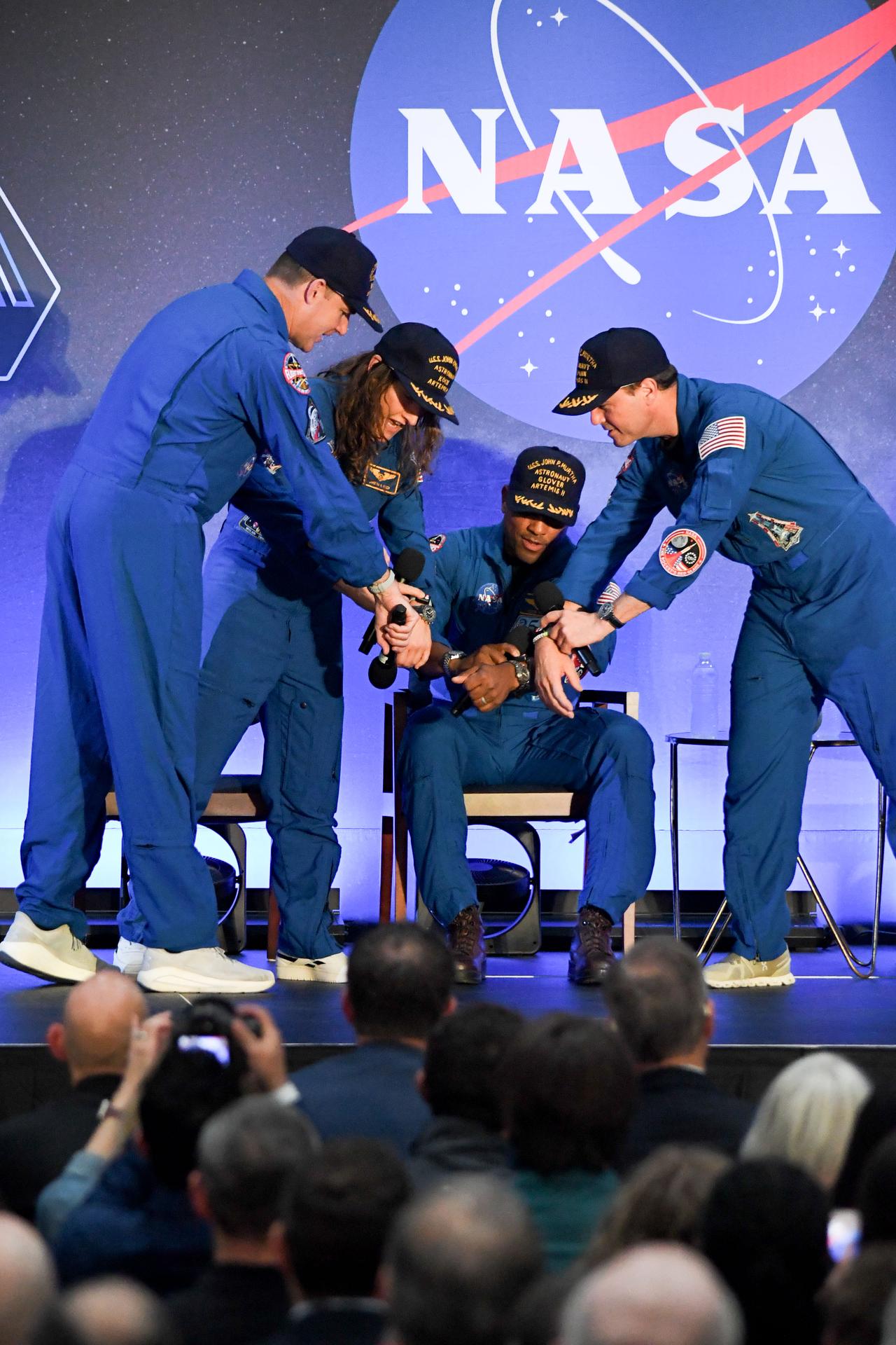 jsc2026e022290 (April 11, 2026) - NASA’s Artemis II crew, NASA astronauts Reid Wiseman, commander; Victor Glover, pilot; Christina Koch, mission specialist; and CSA (Canadian Space Agency) astronaut Jeremy Hansen, shared brief remarks with friends, family, and colleagues after they landed at Ellington Airport near NASA’s Johnson Space Center in Houston on Saturday, April 11, 2026, after a nearly 10-day journey around the Moon and back to Earth. Credit: NASA/Bill Stafford