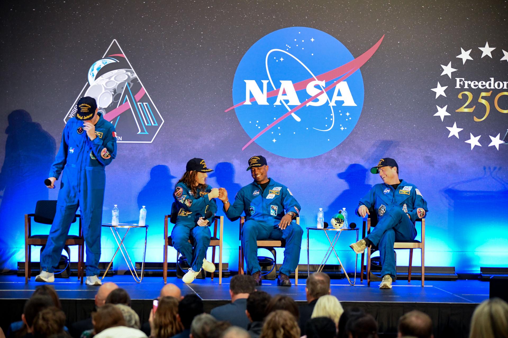 jsc2026e022293 (April 11, 2026) - NASA’s Artemis II crew, NASA astronauts Reid Wiseman, commander; Victor Glover, pilot; Christina Koch, mission specialist; and CSA (Canadian Space Agency) astronaut Jeremy Hansen, shared brief remarks with friends, family, and colleagues after they landed at Ellington Airport near NASA’s Johnson Space Center in Houston on Saturday, April 11, 2026, after a nearly 10-day journey around the Moon and back to Earth. Credit: NASA/Bill Stafford