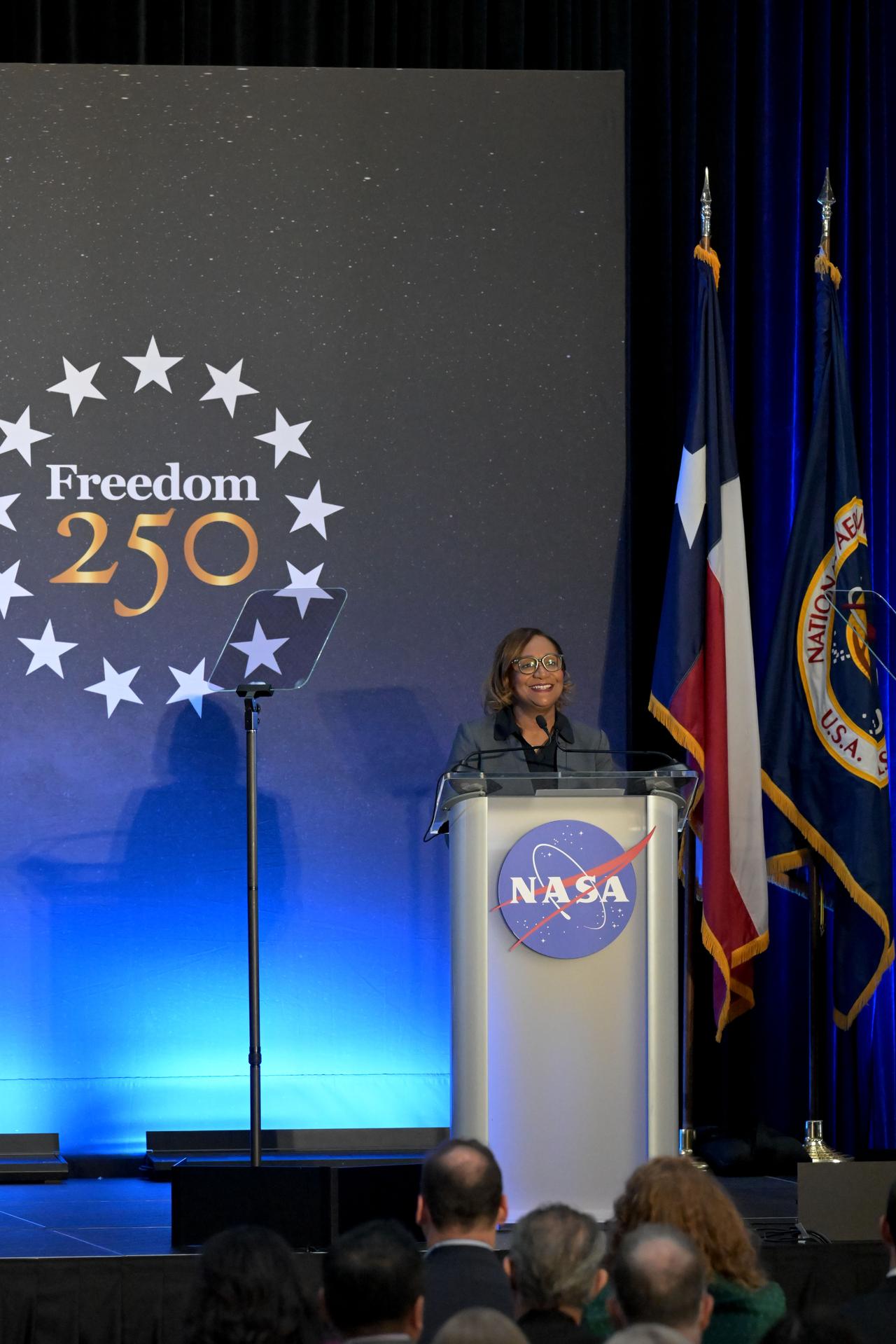 jsc2026e022313 (April 11, 2026) – NASA's Johnson Space Center Director Vanessa Wyche addresses a crowd of friends, family, and colleagues assembled for the return of the Artemis II crew at Ellington Airport near NASA’s Johnson Space Center in Houston on Saturday, April 11, 2026.  The Artemis II test flight launched on Wednesday, April 1, from NASA’s Kennedy Space Center in Florida to begin its 10-day journey around the Moon for scientific discovery, economic benefits, and to build on our foundation for the first crewed missions to Mars. NASA's Orion spacecraft carrying Artemis II Commander Reid Wiseman, Pilot Victor Glover, and Mission Specialist Christina Koch from NASA, along with Mission Specialist Jeremy Hansen from the CSA (Canadian Space Agency), splashed down in the Pacific Ocean near San Diego, California, on Friday, April 10, 2026. Credit: NASA/Bill Stafford