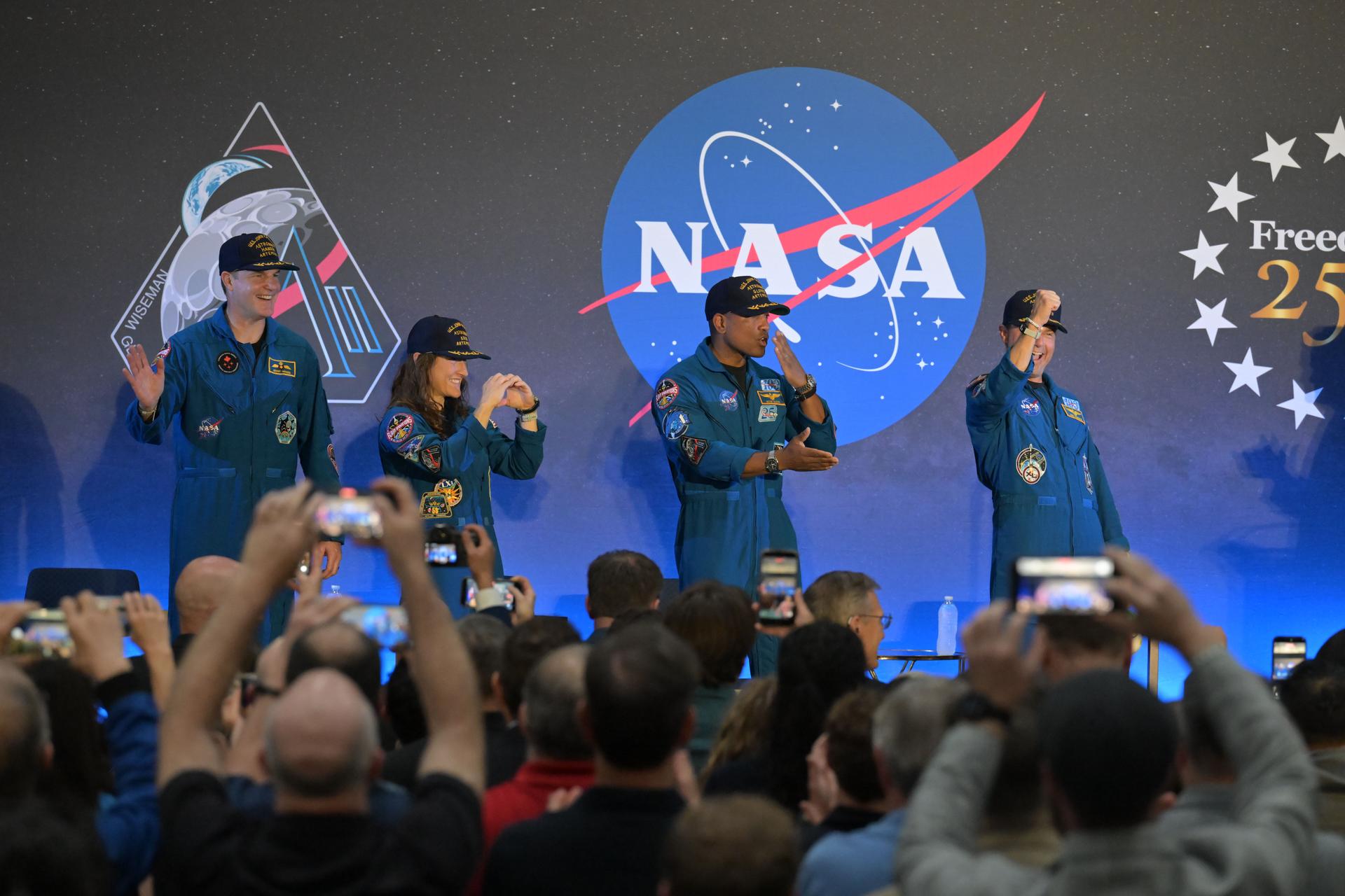 jsc2026e022316 (April 11, 2026) - NASA’s Artemis II crew, NASA astronauts Reid Wiseman, commander; Victor Glover, pilot; Christina Koch, mission specialist; and CSA (Canadian Space Agency) astronaut Jeremy Hansen, shared brief remarks with friends, family, and colleagues after they landed at Ellington Airport near NASA’s Johnson Space Center in Houston on Saturday, April 11, 2026, after a nearly 10-day journey around the Moon and back to Earth. Credit: NASA/Bill Stafford