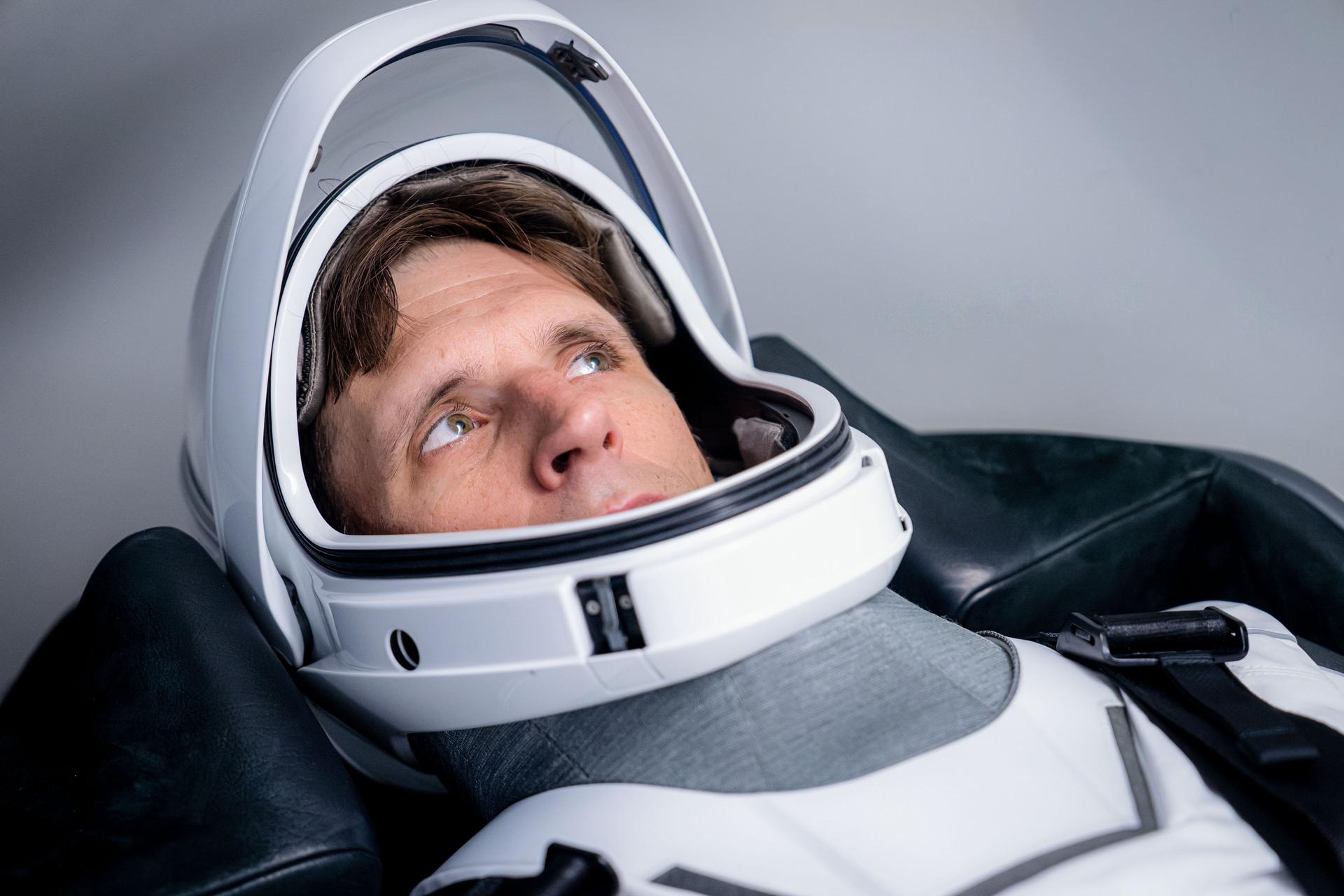 CSA (Canadian Space Agency) astronaut and SpaceX Crew-13 Mission Specialist Joshua Kutryk is pictured in his pressure suit and seated inside a SpaceX Dragon spaceraft during a training session at SpaceX headquarters in Hawthorne, California.