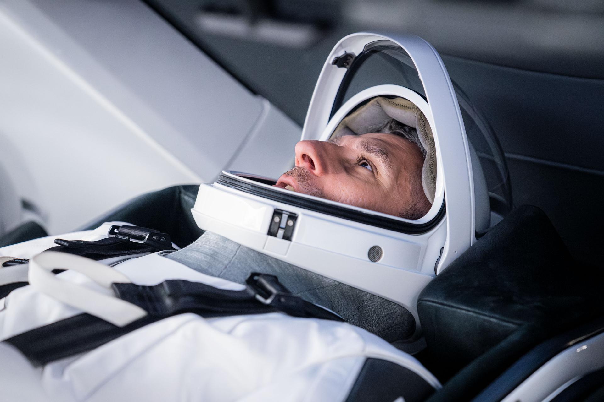 NASA astronaut and SpaceX Crew-13 Pilot Luke Delaney is pictured in his pressure suit and seated inside a SpaceX Dragon spaceraft during a training session at SpaceX headquarters in Hawthorne, California.
