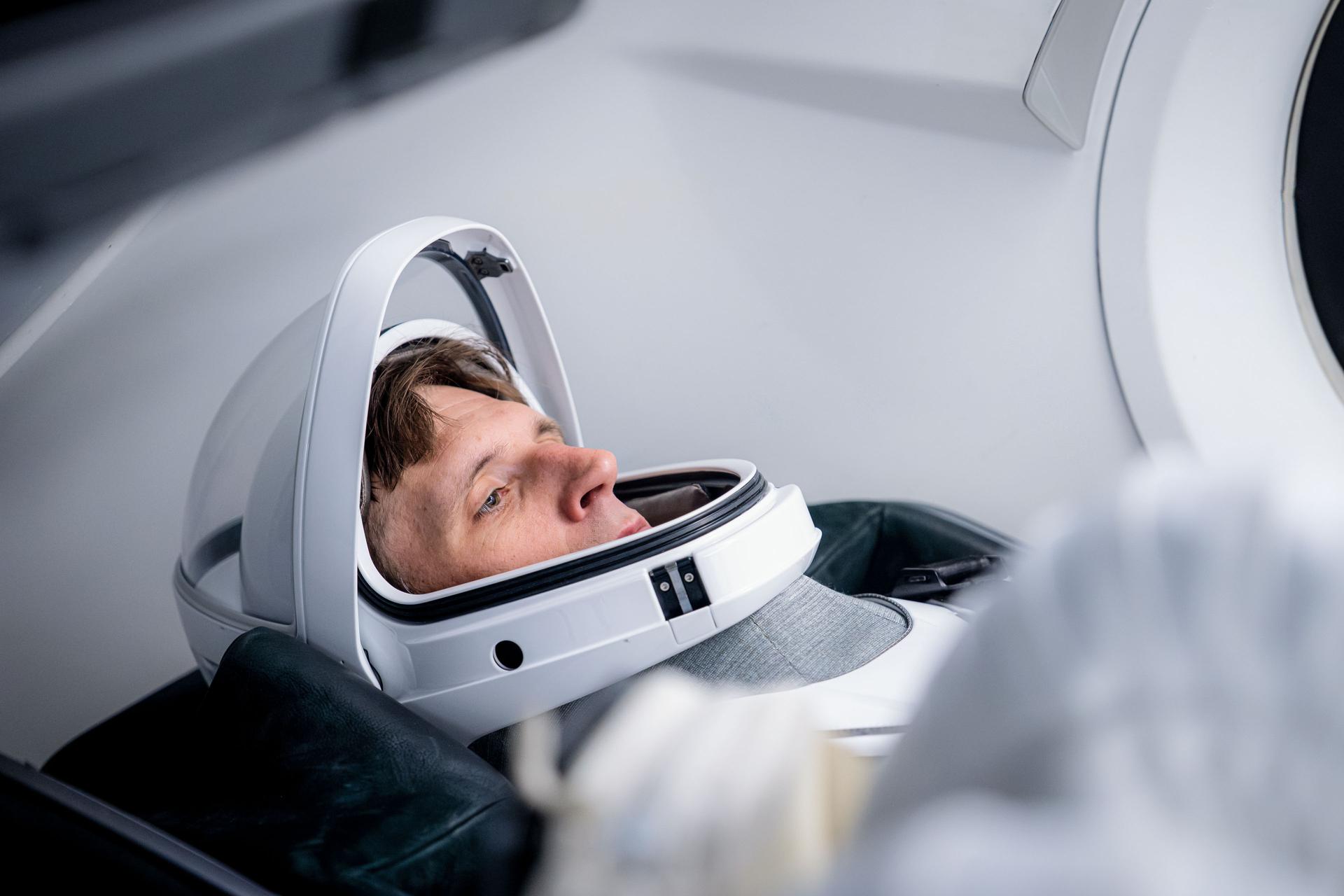 CSA (Canadian Space Agency) astronaut and SpaceX Crew-13 Mission Specialist Joshua Kutryk is pictured in his pressure suit and seated inside a SpaceX Dragon spaceraft during a training session at SpaceX headquarters in Hawthorne, California.