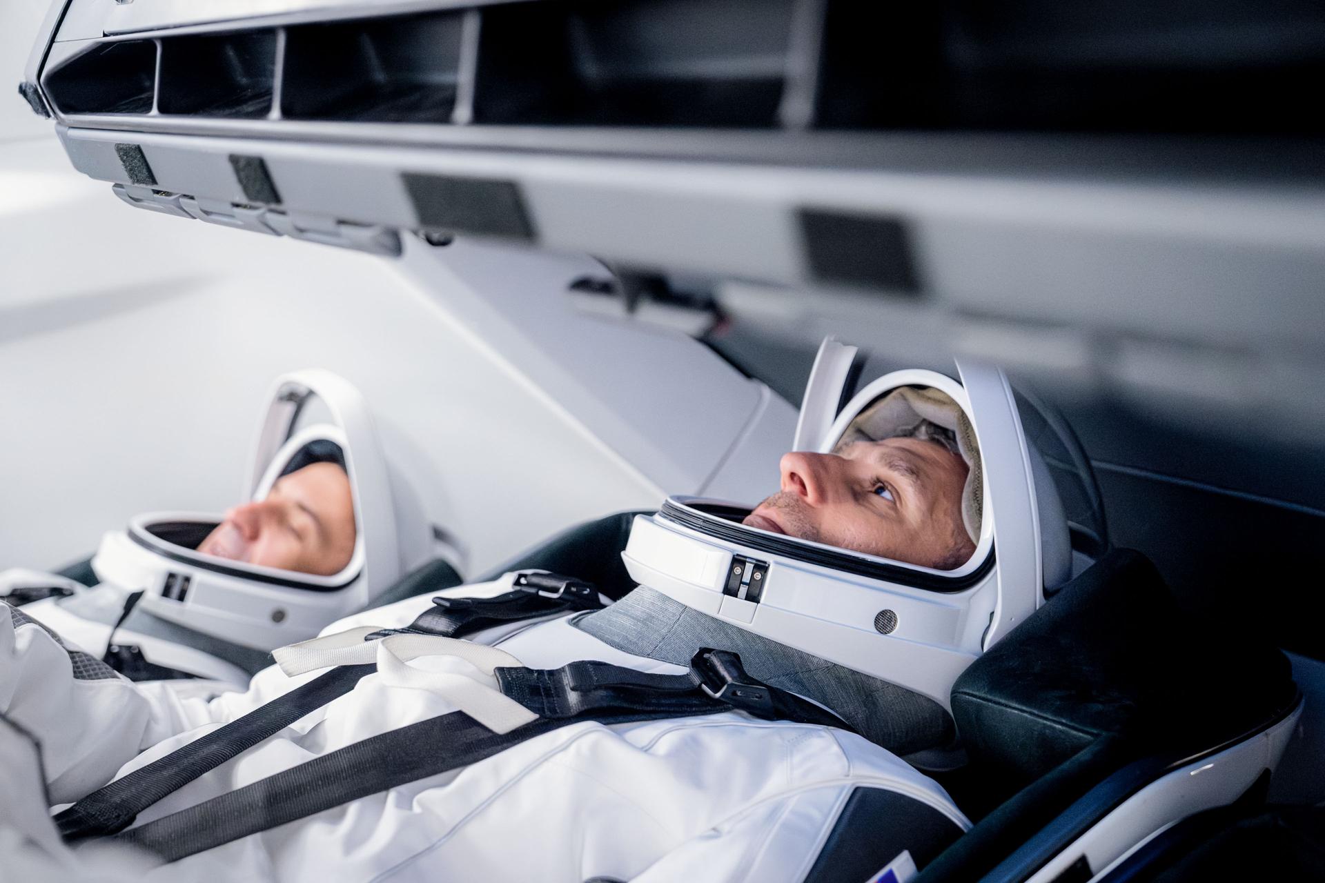 From left, SpaceX Crew-13 Mission Specialist Sergey Teteryatnikov of Roscosmos and Pilot Luke Delaney of NASA are seated inside a SpaceX Dragon spaceraft during a training session at SpaceX headquarters in Hawthorne, California.