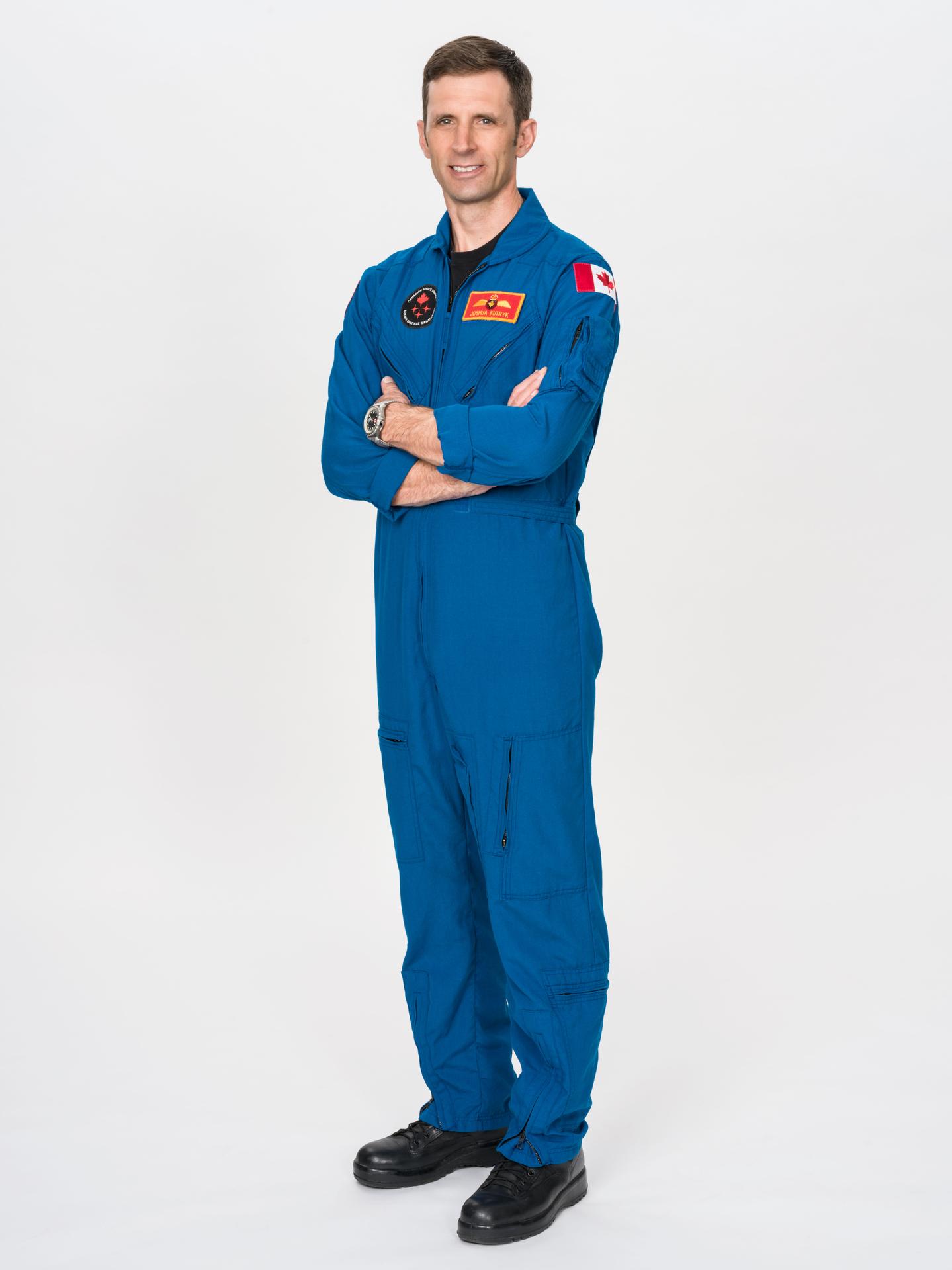 Astronaut Joshua Kutryk of CSA (Canadian Space Agency) poses for an official portrait in a blue flight suit at NASA's Johnson Space Center in Houston, Texas. Kutryk is serving as a mission specialist for NASA's SpaceX Crew-13 mission to the International Space Station.