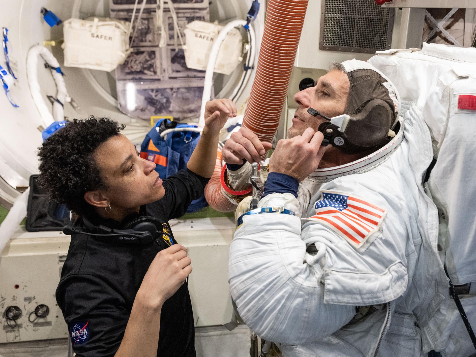 NASA astronaut Jessica Watkins assists NASA astronaut Luke Delaney as he practices suiting up in a spacesuit in an International Space Station airlock simulator at Johnson Space Center’s (JSC) Space Vehicle Mockup Facility in Houston, Texas. Astronauts familiarize themselves with spacesuit systems and procedures and practice Quest airlock operations before conducting spacewalk training at JSC’s Neutral Buoyancy Laboratory in simulated microgravity.