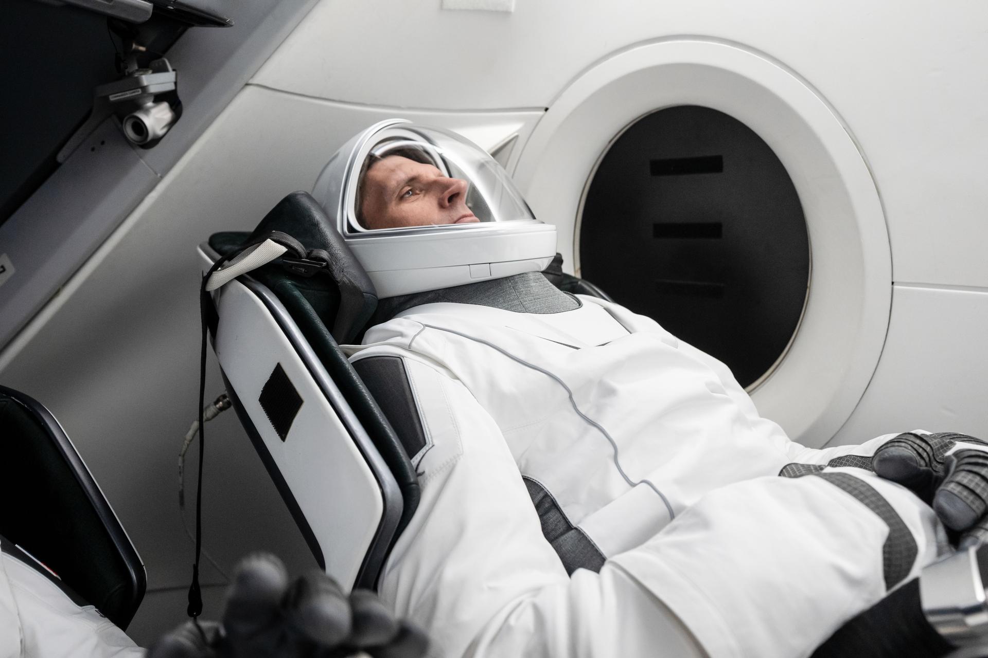 CSA (Canadian Space Agency) astronaut and SpaceX Crew-13 mission specialist Josh Kutryk is pictured in his pressure suit seated inside a mockup Dragon spacecraft during a preflight training session at the company's headquarters in Hawthorne, California.