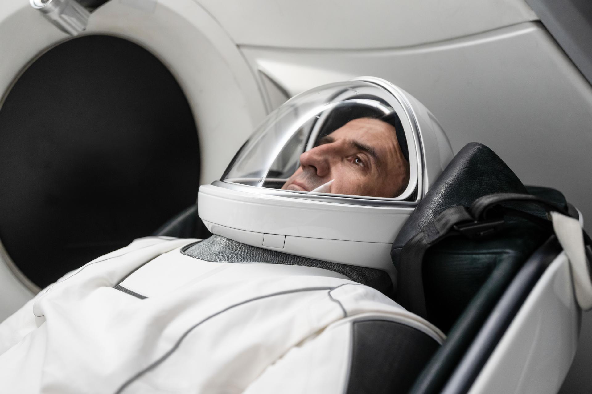Roscosmos cosmonaut and SpaceX Crew-13 mission specialist Sergey Teteryatnikov is pictured in his pressure suit seated inside a mockup Dragon spacecraft during a preflight training session at the company's headquarters in Hawthorne, California.