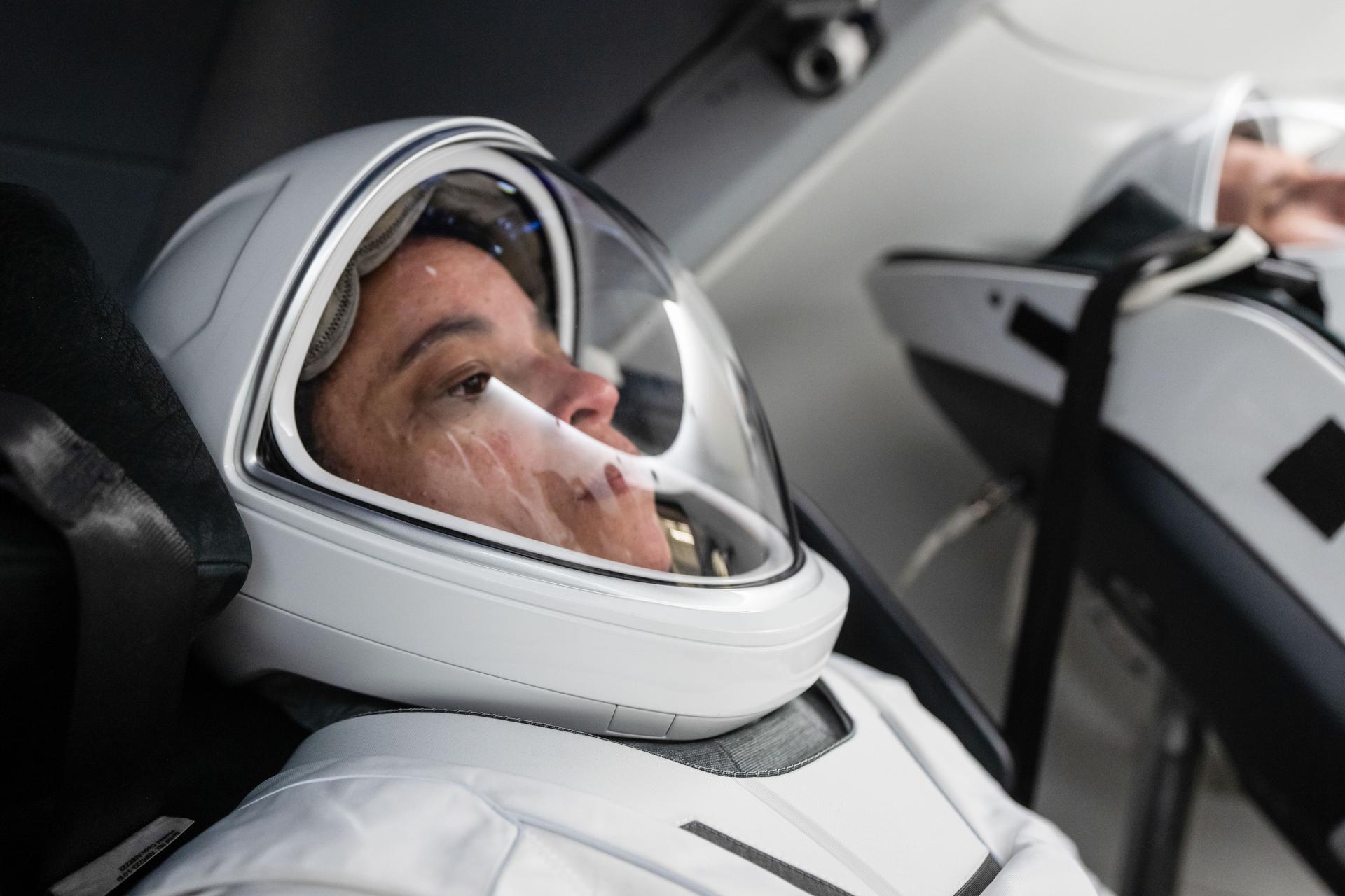 NASA astronaut and SpaceX Crew-13 commander Jessica Watkins is pictured in her pressure suit seated inside a mockup Dragon spacecraft during a preflight training session at the company's headquarters in Hawthorne, California.