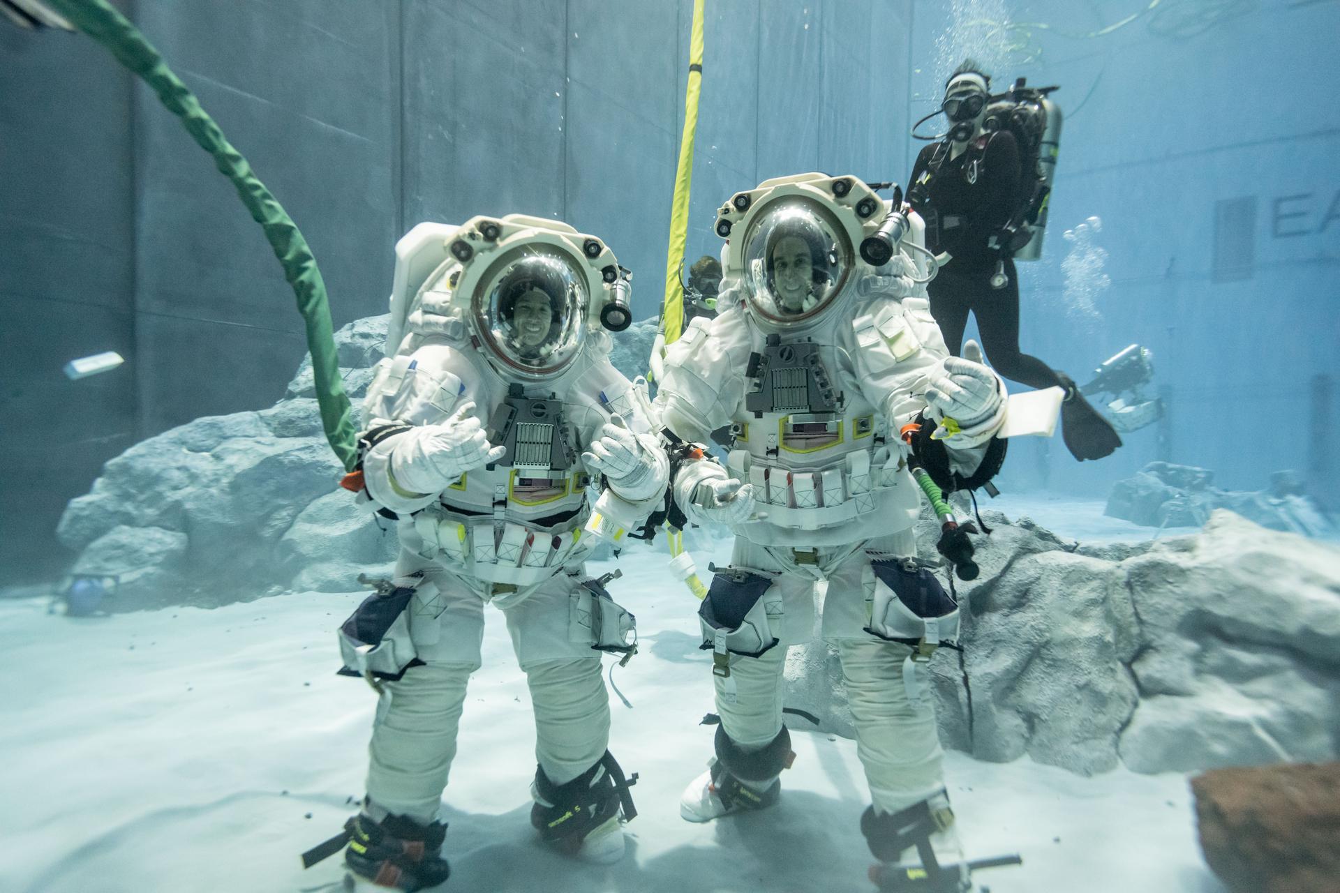 Exploration geologists and Artemis science officers Trevor Graff, left, and Angela Garcia carry out a lunar training development run at NASA’s Neutral Buoyancy Laboratory (NBL) in Houston. The NBL is a 40-foot deep pool at NASA’s Johnson Space Center where astronauts train for spacewalks in a neutrally buoyant environment. During the session, Garcia and Graff conducted tests of Artemis geology tools and deployed a mock lunar payload under low-angle lighting conditions similar to what astronauts will encounter at the Moon’s south pole. A section of the NBL, which contains full-scale mockups of the International Space Station modules, has been transformed into a lunar training area with soil and rocks that mimic the Moon’s landscape. This testing run marked the first time in the Artemis program that two geologists were suited up simultaneously for lunar geology training in the NBL. The team is using insights from these tests to build the training program for astronauts assigned to future landed missions on the Moon. Credit: NASA