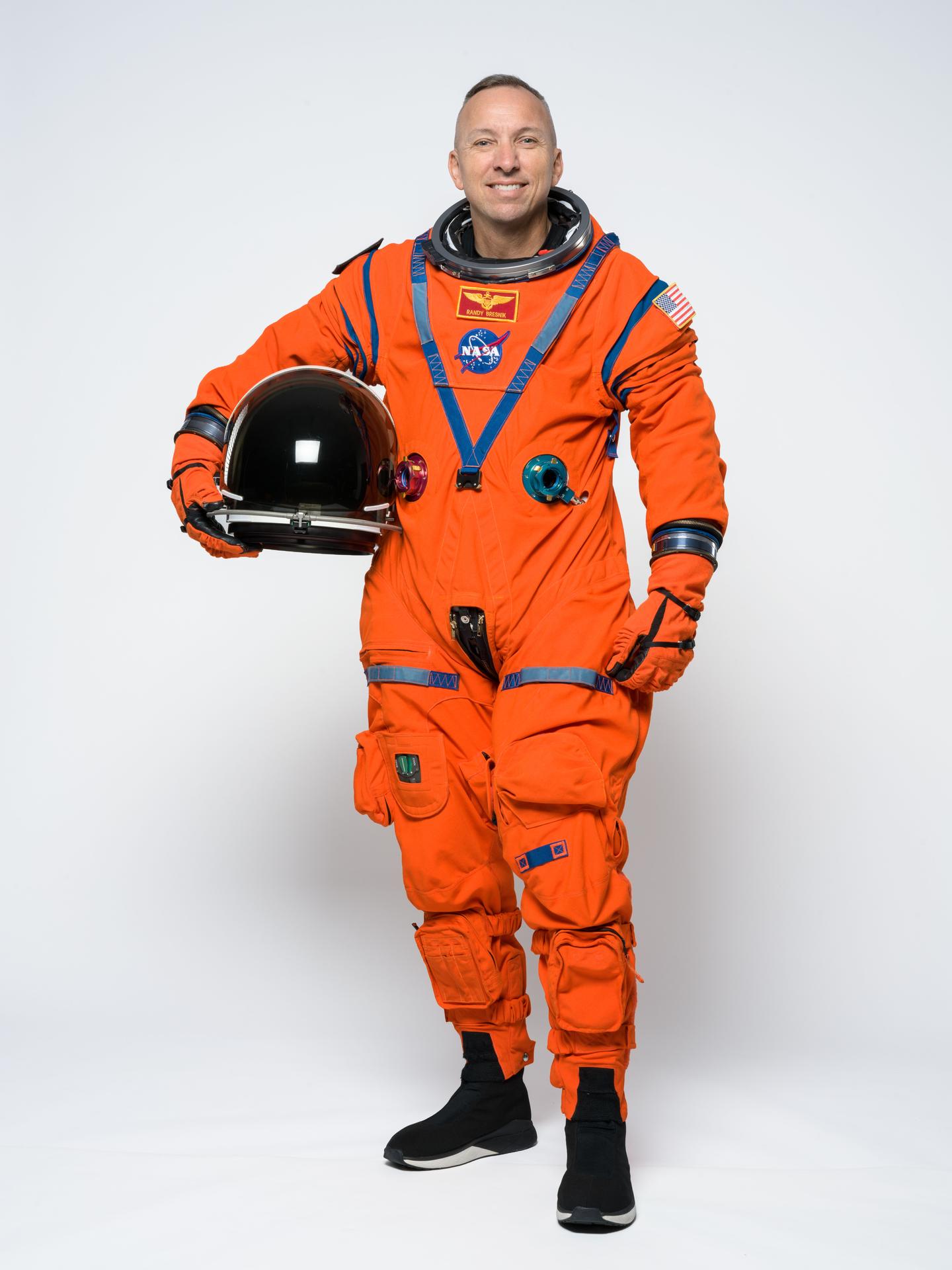 Artemis III commander Randy Bresnik poses for a portrait in the orange Orion Crew Survival System suit. Credit: NASA/Helen Arase Vargas 