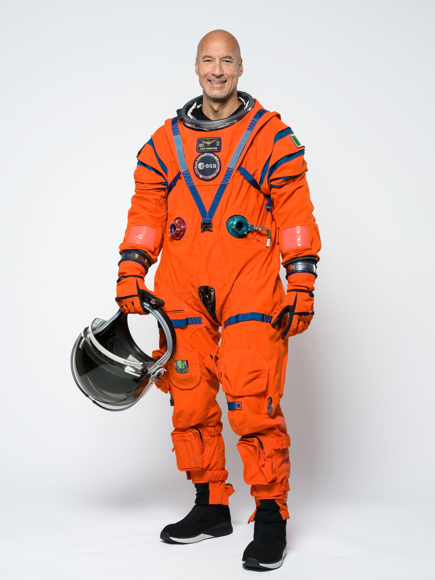 Artemis III pilot Luca Parmitano poses for a portrait in the orange Orion Crew Survival System suit. Credit: NASA/Helen Arase Vargas