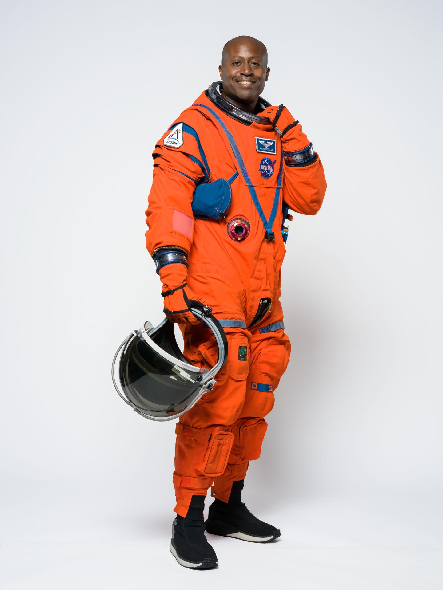 Artemis III mission specialist Andre Douglas poses for a portrait in the orange Orion Crew Survival System suit. Credit: NASA/Helen Arase Vargas 