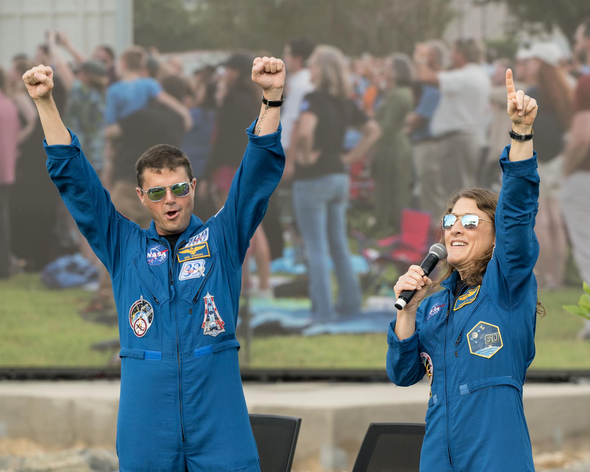 jsc2026e396751 (June 25, 2026) - NASA astronauts Reid Wiseman and Christina Koch address the crowd at an Artemis II employee celebration event at NASA's Johnson Space Center. Credit: NASA