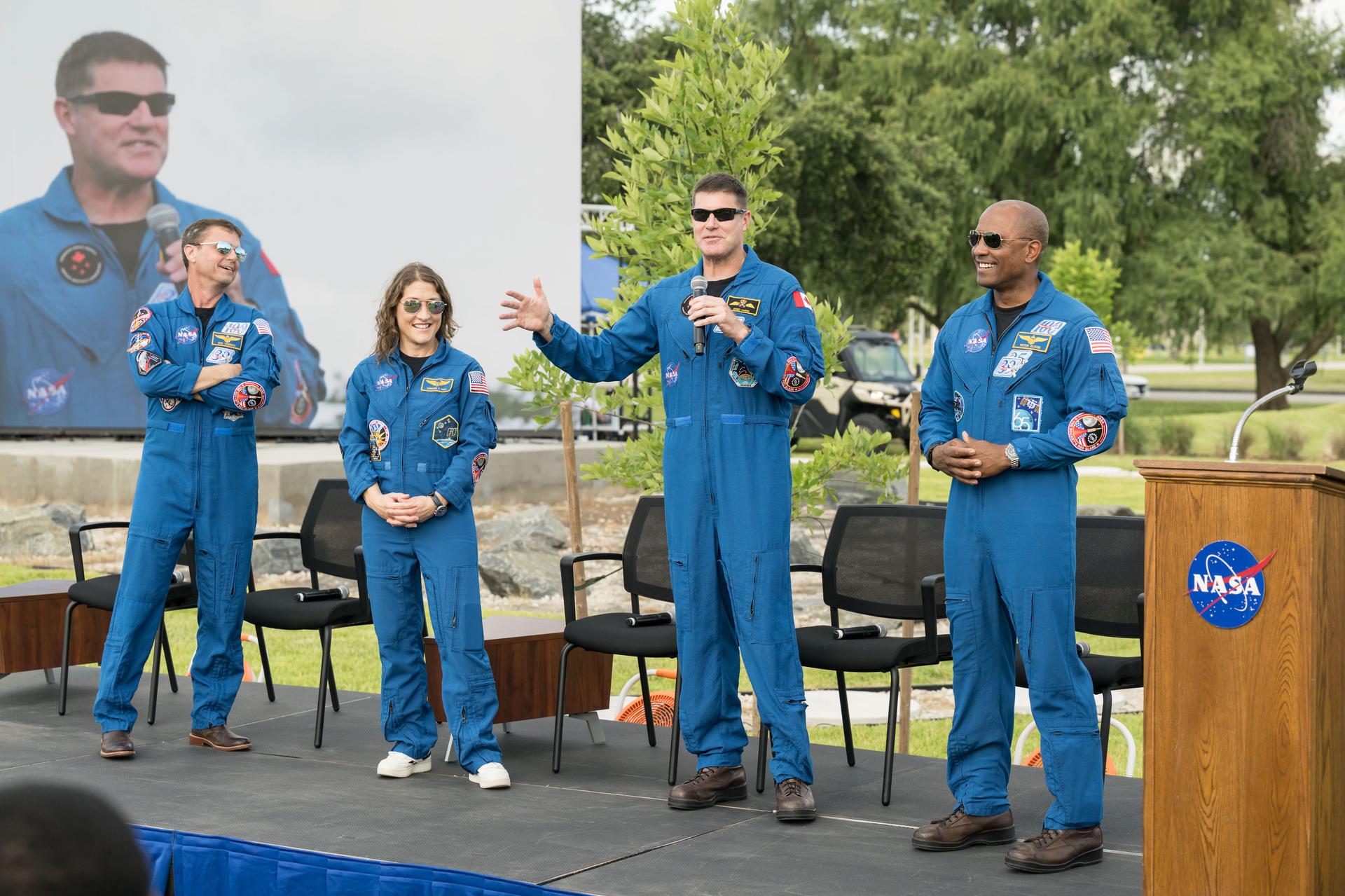 jsc2026e396755 (June 25, 2026) - CSA (Canadian Space Agency) astronaut Jeremy Hansen addresses the crowd alongside his fellow Artemis II crew members at an Artemis II employee celebration event at NASA's Johnson Space Center. Credit: NASA