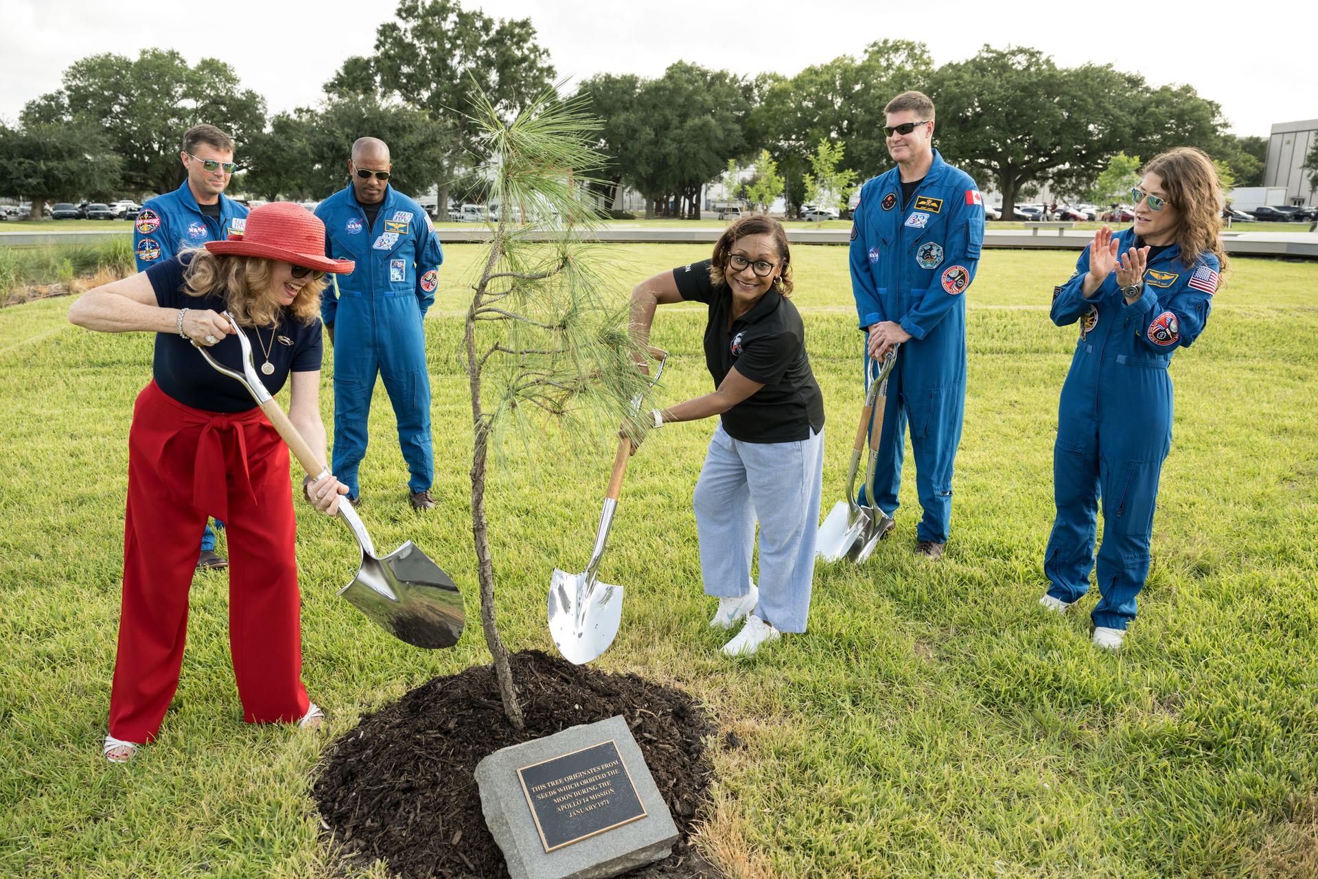 jsc2026e396760 (June 25, 2026) - From left to right, Rosemary Roosa, president of The Moon Tree Foundation and daughter of late Apollo 14 astronaut Stuart Roosa, and Vanessa Wyche, director of NASA's Johnson Space Center, participate in the dedication of the Apollo 14 Moon tree alongside the Artemis II crew. This tree is a second-generation Apollo Moon tree of the loblolly pine species. The original Apollo Moon trees were grown from seeds carried aboard Apollo 14 by NASA astronaut Stuart Roosa, a former U.S. Forest Service smoke jumper. Upon return to Earth, the seeds were germinated by the Forest Service, and the resulting seedlings were planted throughout the United States and around the world. Credit: NASA