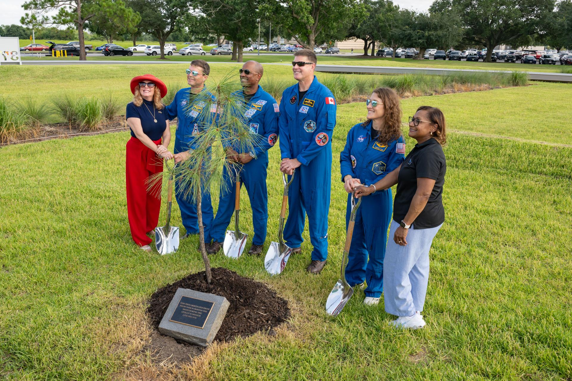 jsc2026e397475 (June 25, 2026) - From left to right, Rosemary Roosa, president of The Moon Tree Foundation and daughter of late Apollo 14 astronaut Stuart Roosa, and Vanessa Wyche, director of NASA's Johnson Space Center, participate in the dedication of the Apollo 14 Moon tree alongside the Artemis II crew. Credit: This tree is a second-generation Apollo Moon tree of the loblolly pine species. The original Apollo Moon trees were grown from seeds carried aboard Apollo 14 by NASA astronaut Stuart Roosa, a former U.S. Forest Service smoke jumper. Upon return to Earth, the seeds were germinated by the Forest Service, and the resulting seedlings were planted throughout the United States and around the world. Credit: NASA