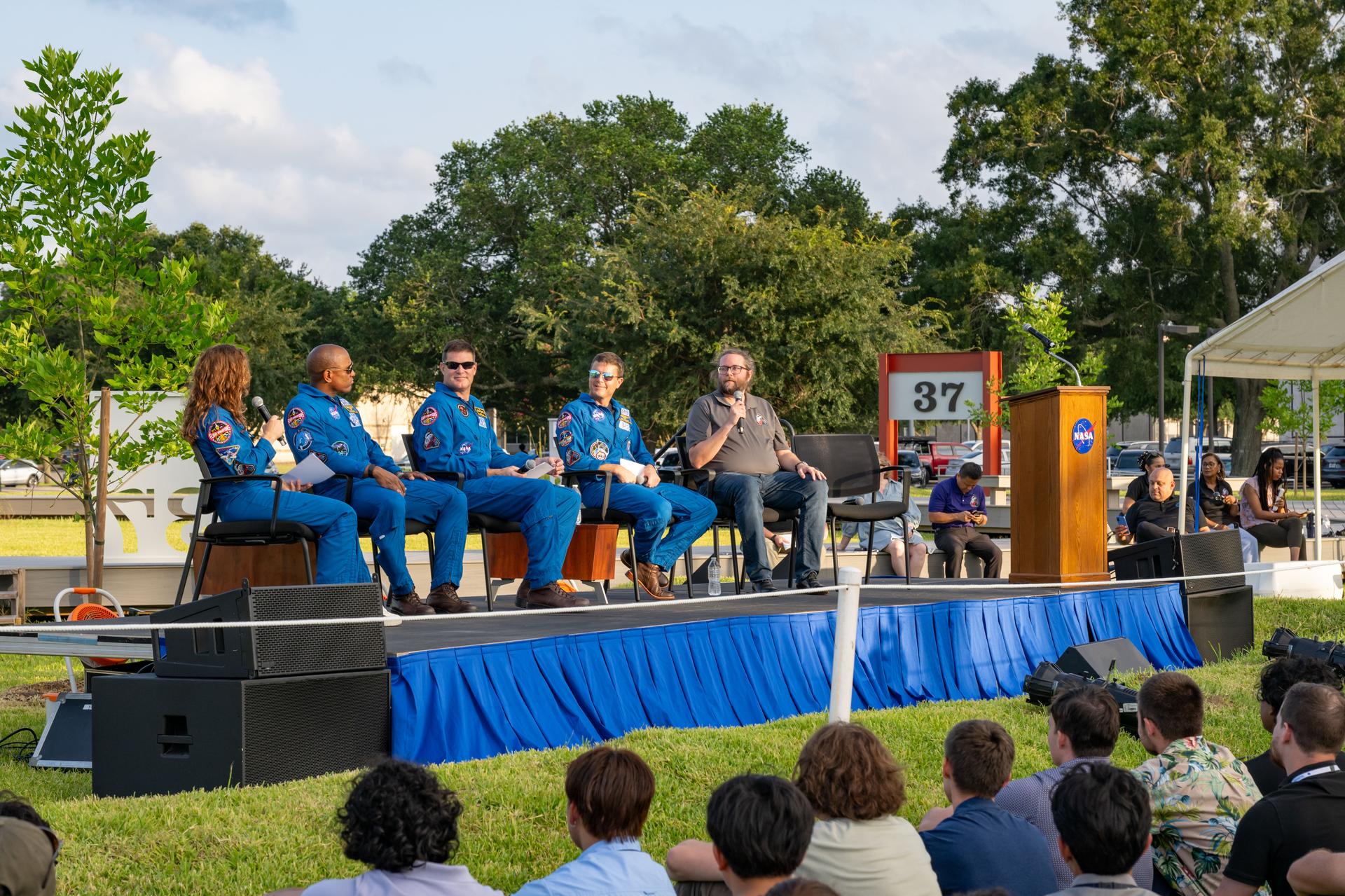 jsc2026e397499 (June 25, 2026) - Sean Duval, Artemis II Mission Lead, answers questions from the Artemis II crew during an Artemis II employee celebration event at the Lunar Receiving Park at NASA's Johnson Space Center. Credit: NASA