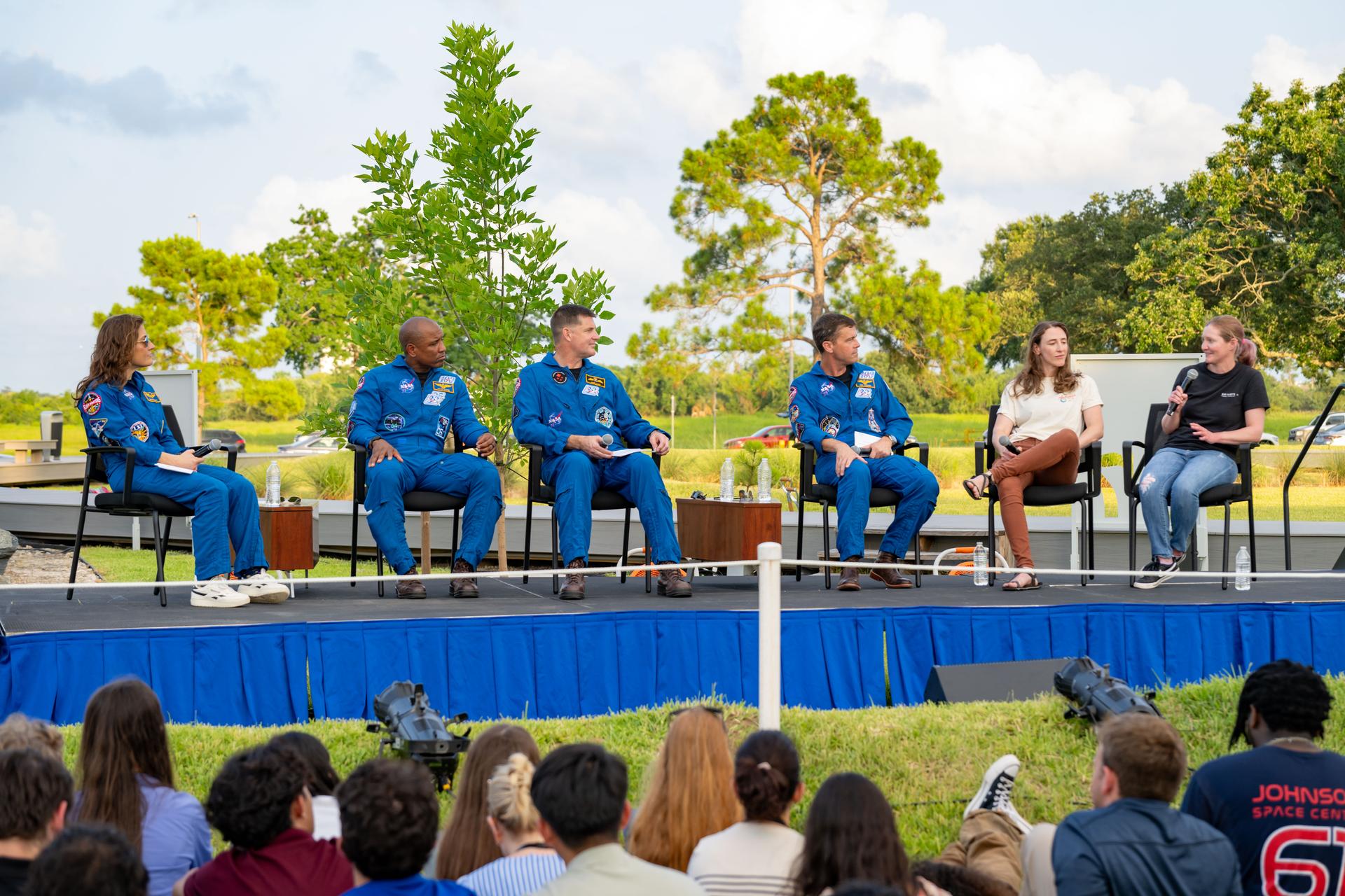 jsc2026e397512 (June 25, 2026) - Natasha Peake, Flight Dynamics Officer, and Emily Kollin, Orion MER Control Console Operator, answer questions from the Artemis II crew during an employee celebration event at NASA's Johnson Space Center. Credit: NASA