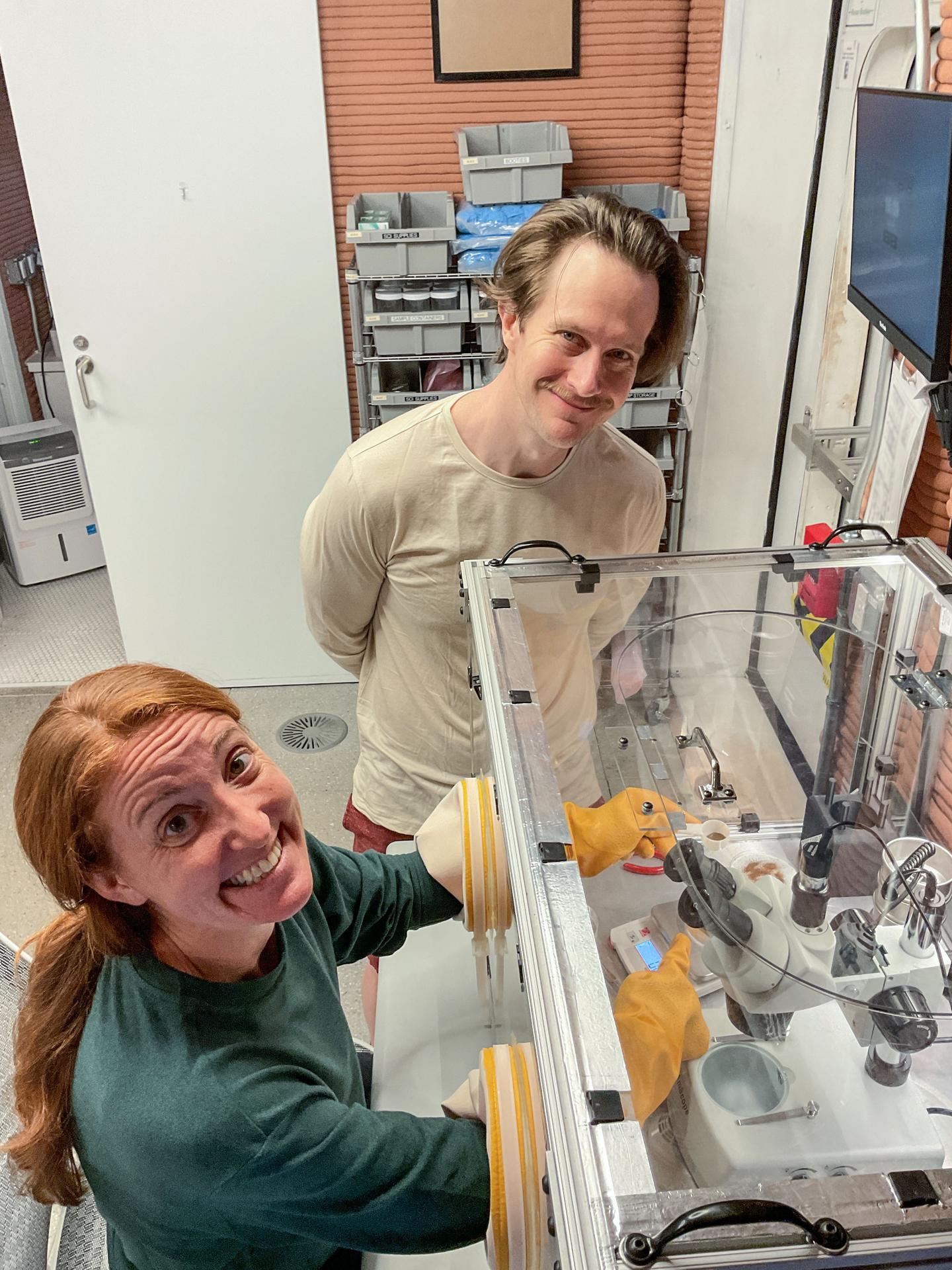 jsc2026e403162 (Oct. 21, 2025) -- Crew Health and Performance Exploration Analog (CHAPEA) mission 2 crew members use the glove box inside the habitat (From left: Ellen Ellis, Matthew Montgomery). Credit: NASA
