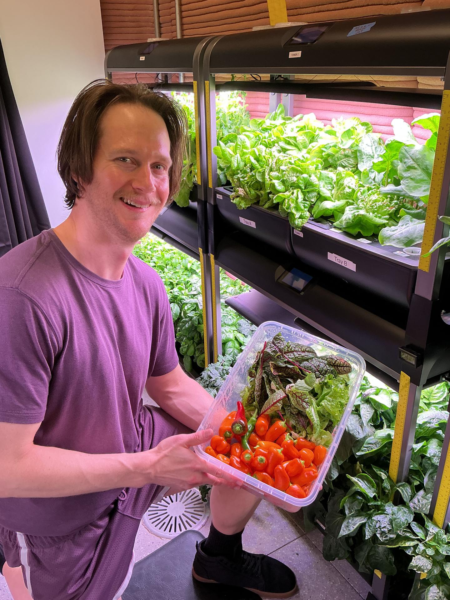 jsc2026e403163 (Feb. 4, 2026) -- Matthew Montgomery, Crew Health and Performance Exploration Analog (CHAPEA) Mission 2 science officer, showcases vegetables collected during a recent harvest from the hydroponic crop growth system. Credit: NASA