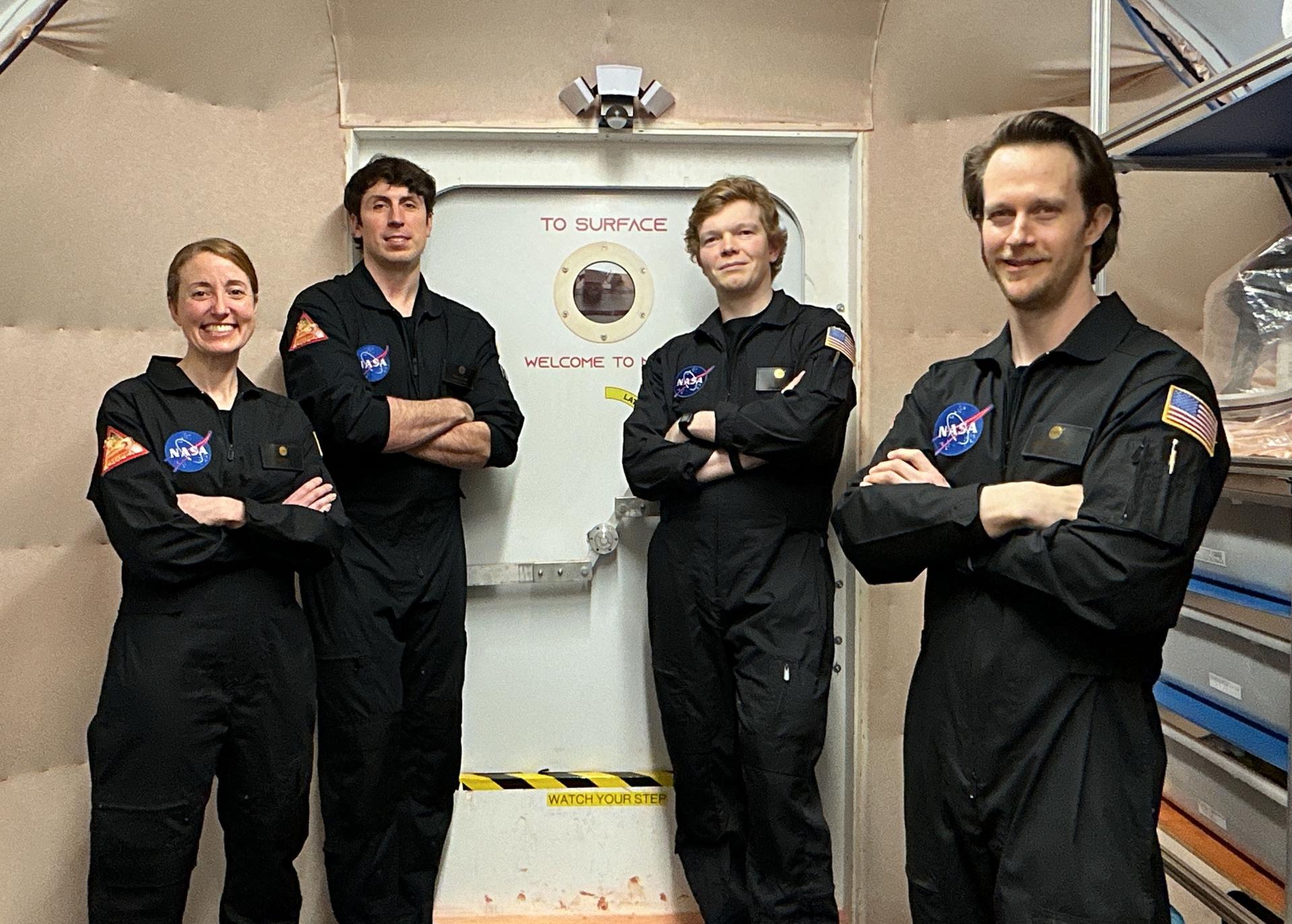 jsc2026e403170 (March 14, 2026) -- Members of NASA’s CHAPEA (Crew Health and Performance Exploration Analog) mission 2 pose for a group photo. (From left to right: Ellen Ellis, Ross Elder, James Spicer, and Matthew Montgomery). Credit: NASA
