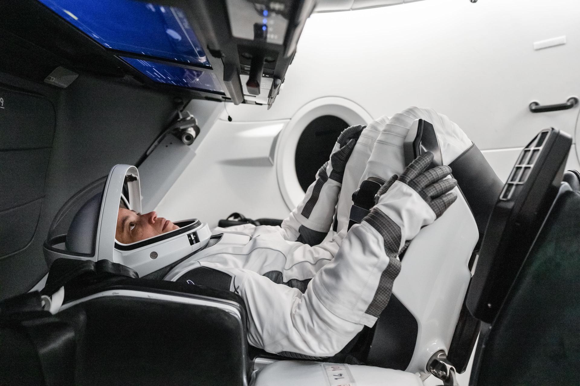 NASA astronaut and SpaceX Crew-13 Commander Jessica Watkins sits inside a Dragon spacecraft mockup while reading a cockpit screen interface during a pre-flight training session at SpaceX headquarters in Hawthorne, California.