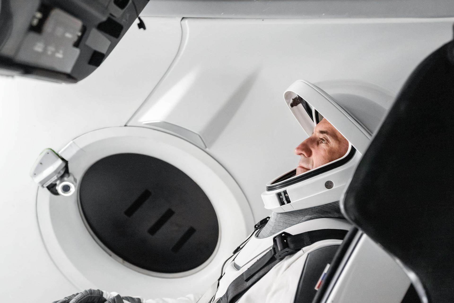 Roscosmos cosmonaut and SpaceX Crew‑13 Mission Specialist Sergey Teteryatnikov sits inside a Dragon spacecraft mockup while participating in a pre‑flight training session at SpaceX headquarters in Hawthorne, California.