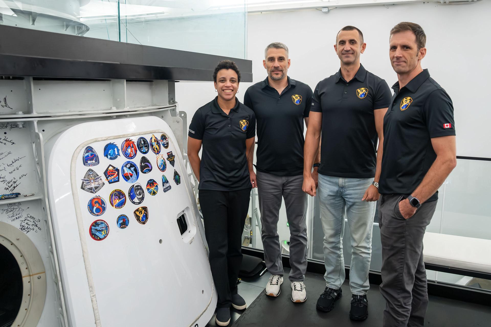 jsc2026e406103 (July 30, 3036) --- The four members representing NASA's SpaceX Crew-13 mission to the International Space Station pose for a portrait next to the Dragon spacecraft mockup after completing a pre‑flight training session at SpaceX headquarters in Hawthorne, California. Credit: SpaceX