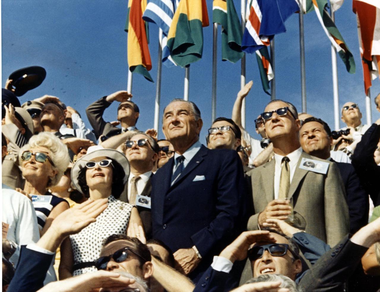 KENNEDY SPACE CENTER, FLA. -- Vice President Spiro Agnew [right center] and Former President Lyndon Johnson (left center] view the liftoff of Apollo 11 from the stands located at the Kennedy Space Center VIP viewing site. The two political figures were at the Kennedy Space Center to witness the launch of the first Manned Lunar Landing mission which took place from Pad 39A at 9:32 a.m. EDT.