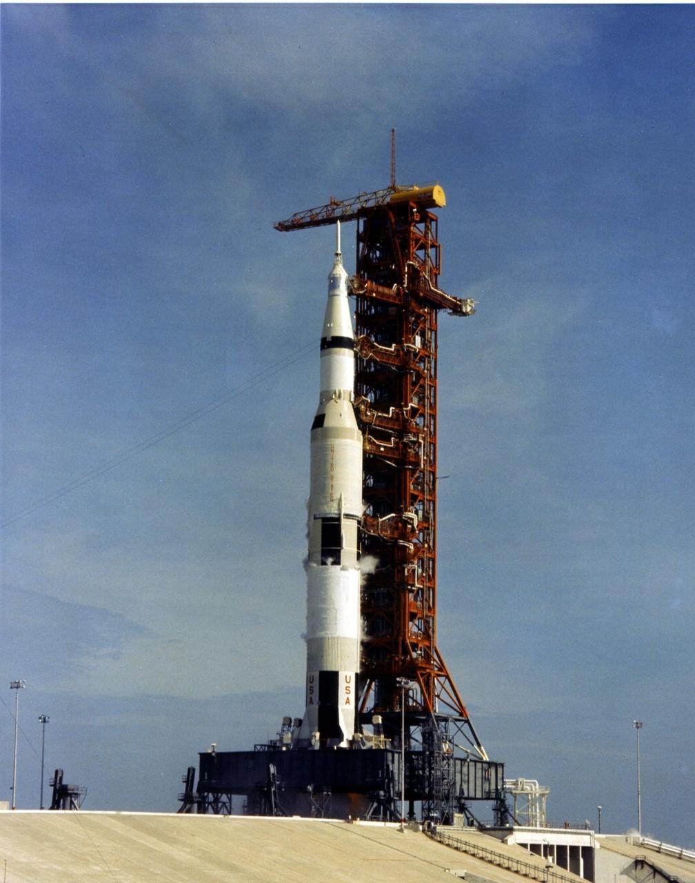 KENNEDY SPACE CENTER, FLA. -- The Apollo 11 Saturn V space vehicle, at Launch Pad 39A, awaits the liftoff scheduled for 9:32 a.m. EDT today, along with astronauts Neil A. Armstrong, Michael Collins and Edwin E. Aldrin Jr. During the planned eight-day mission, Armstrong and Aldrin will descend in a lunar module to the Moon's surface while Collins orbits overhead in the command module. The two astronauts are to spend 22 hours on the Moon, including two and one-half hours outside the lunar module. They will gather samples of lunar material and will deploy scientific experiments which will transmit data about the lunar environment. They will rejoin Collins the command module for the return trip to Earth