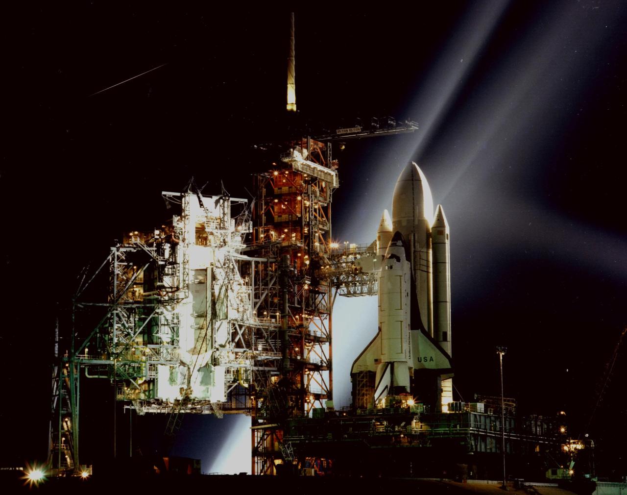KENNEDY SPACE CENER, FLA. -- A timed exposure of the Space Shuttle at Launch Pad A, Complex 39, turns the space vehicle and support facilities into a night-time fantasy of light. To the left of the Shuttle are the fixed and the rotating service structures