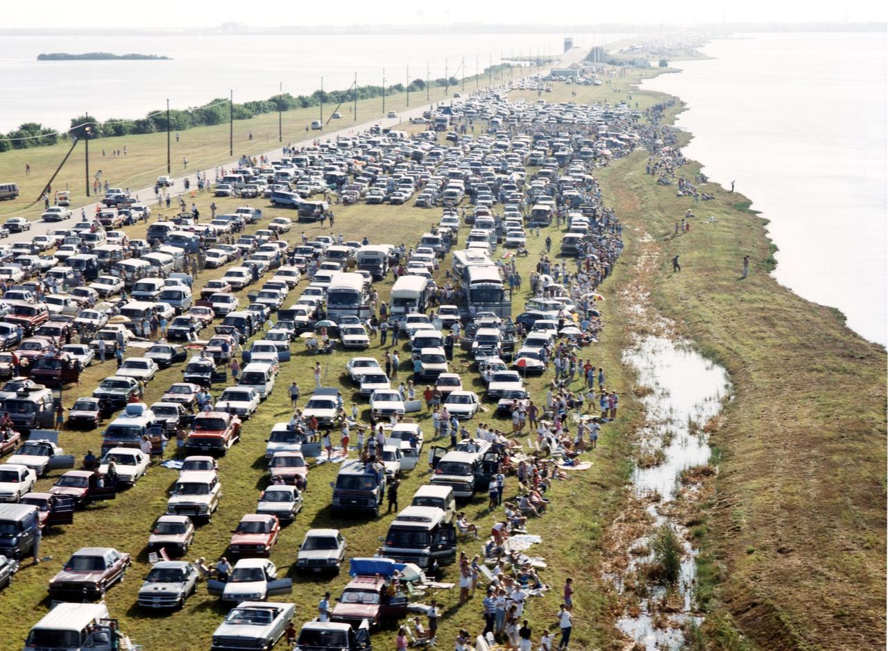 NASA employees, their family and friends gather on the NASA causeway over the Banana River, south of Kennedy Space Center, the morning of the launch of STS-26 and the Space Shuttle Discovery. An estimated 1 million people were expected to view the 11:37 a.m. launch from various locations in Central Florida