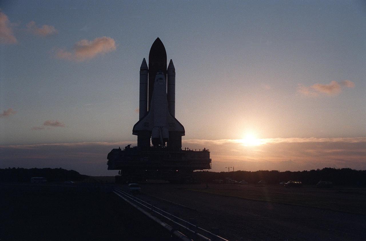 KENNEDY SPACE CENTER, FLA. - As the sun begins to rise in the early-morning sky, the Space Shuttle Atlantis slowly travels on the Crawlerway toward the Vehicle Assembly Building after its departure from Launch Pad 39A. This marks the second rollback for Atlantis since July because of hurricane threats. Atlantis, which is targeted for liftoff later this month on the STS-79 Shuttle mission, is returning to the VAB because of the threat from Hurrican Fran. The threat of Hurrican Bertha forced the rollback of Atlantis in July. Atlantis is currently scheduled for launch on the fourth Shuttle-MIR docking mission around mid-September