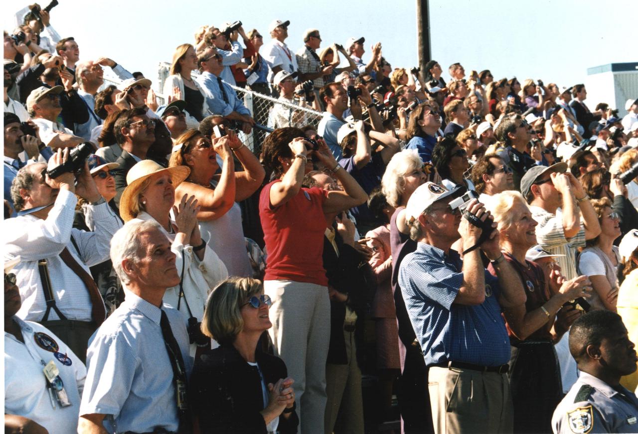 These stands are filled with spectators watching and photographing the launch of STS-95. The viewing sites and roadways at Kennedy Space Center bulge with people and vehicles wanting to see Space Shuttle Discovery lift off. Extra attention has been drawn to the mission due to the addition to the crew of John H. Glenn Jr., a senator from Ohio. STS-95 is Glenn's second flight into space after 36 years; he was one of the original Project Mercury astronauts and flew his first mission in February 1962. The STS-95 mission includes research payloads such as the Spartan solar-observing deployable spacecraft, the Hubble Space Telescope Orbital Systems Test Platform, the International Extreme Ultraviolet Hitchhiker, as well as a SPACEHAB single module with experiments on space flight and the aging process