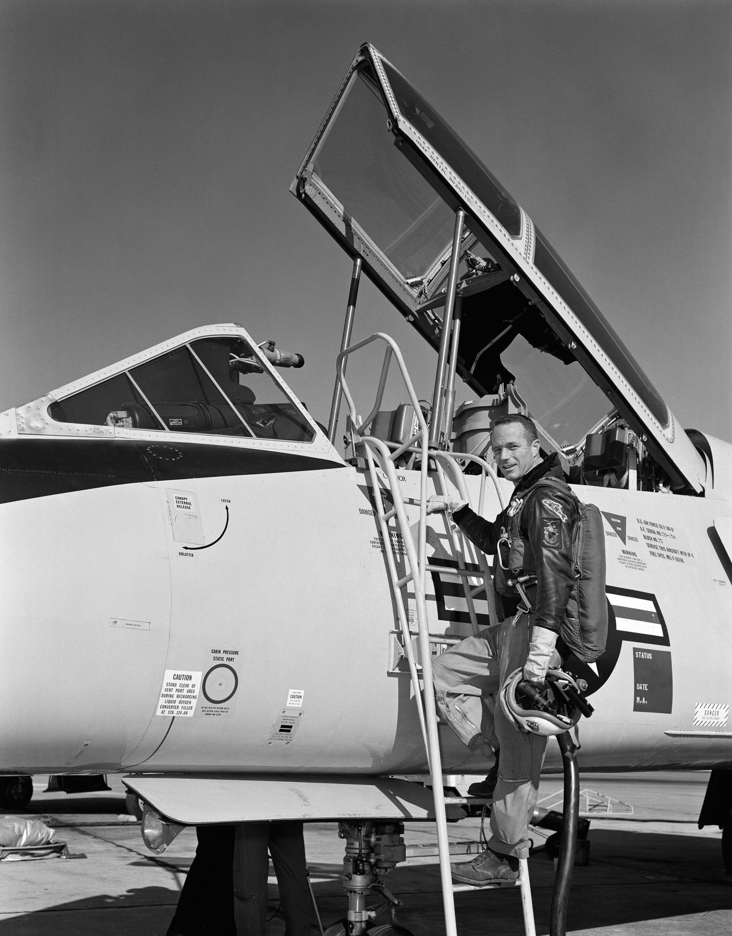 Astronaut Scott Carpenter climbs the ladder to the cockpit of a F-106.