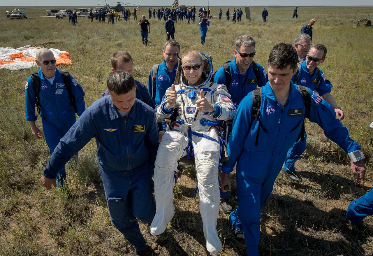 Tim Kopra of NASA is carried to a medical tent after he and Tim Peake of the European Space Agency and Yuri Malenchenko of Roscosmos landed in their Soyuz TMA-19M spacecraft in a remote area near the town of Zhezkazgan, Kazakhstan on Saturday, June 18, 2016. Kopra, Peake, and Malenchenko are returning after six months in space where they served as members of the Expedition 46 and 47 crews onboard the International Space Station. Photo Credit: (NASA/Bill Ingalls)