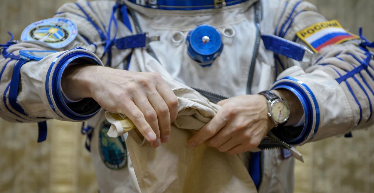 Expedition 49 Russian cosmonaut Sergei Ryzhikov of Roscosmos dons his Russian Sokol suit ahead of the Soyuz qualification exams with fellow Russian cosmonaut Andrey Borisenko of Roscosmos and NASA astronaut Shane Kimbrough, Wednesday, Aug. 31, 2016, at the Gagarin Cosmonaut Training Center (GCTC) in Star City, Russia. Photo Credit: (NASA/Bill Ingalls)