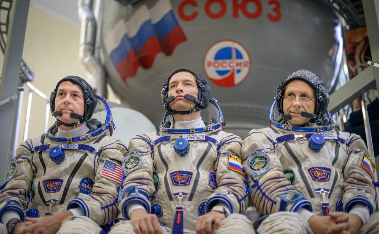 Expedition 49 NASA astronaut Shane Kimbrough, left, Russian cosmonaut Sergei Ryzhikov of Roscosmos, center, and Russian cosmonaut Andrey Borisenko of Roscosmos answer questions from the press outside the Soyuz simulator ahead of their Soyuz qualification exams, Wednesday, Aug. 31, 2016, at the Gagarin Cosmonaut Training Center (GCTC) in Star City, Russia. Photo Credit: (NASA/Bill Ingalls)