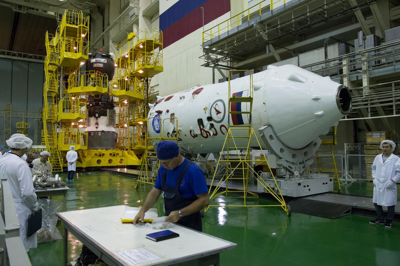 Workers prepare to encapsulate the Soyuz MS-02 spacecraft in its fairing on Thursday, Sept. 15, 2016 at the Baikonur Cosmodrome in Kazakhstan. Expedition 49 flight engineer Shane Kimbrough of NASA, flight engineer Andrey Borisenko of Roscosmos, and Soyuz commander Sergey Ryzhikov of Roscosmos are scheduled to launch to the International Space Station aboard the Soyuz MS-02 spacecraft from the Baikonur Cosmodrome on September 24 Kazakh time. Photo Credit: (NASA/Victor Zelentsov)